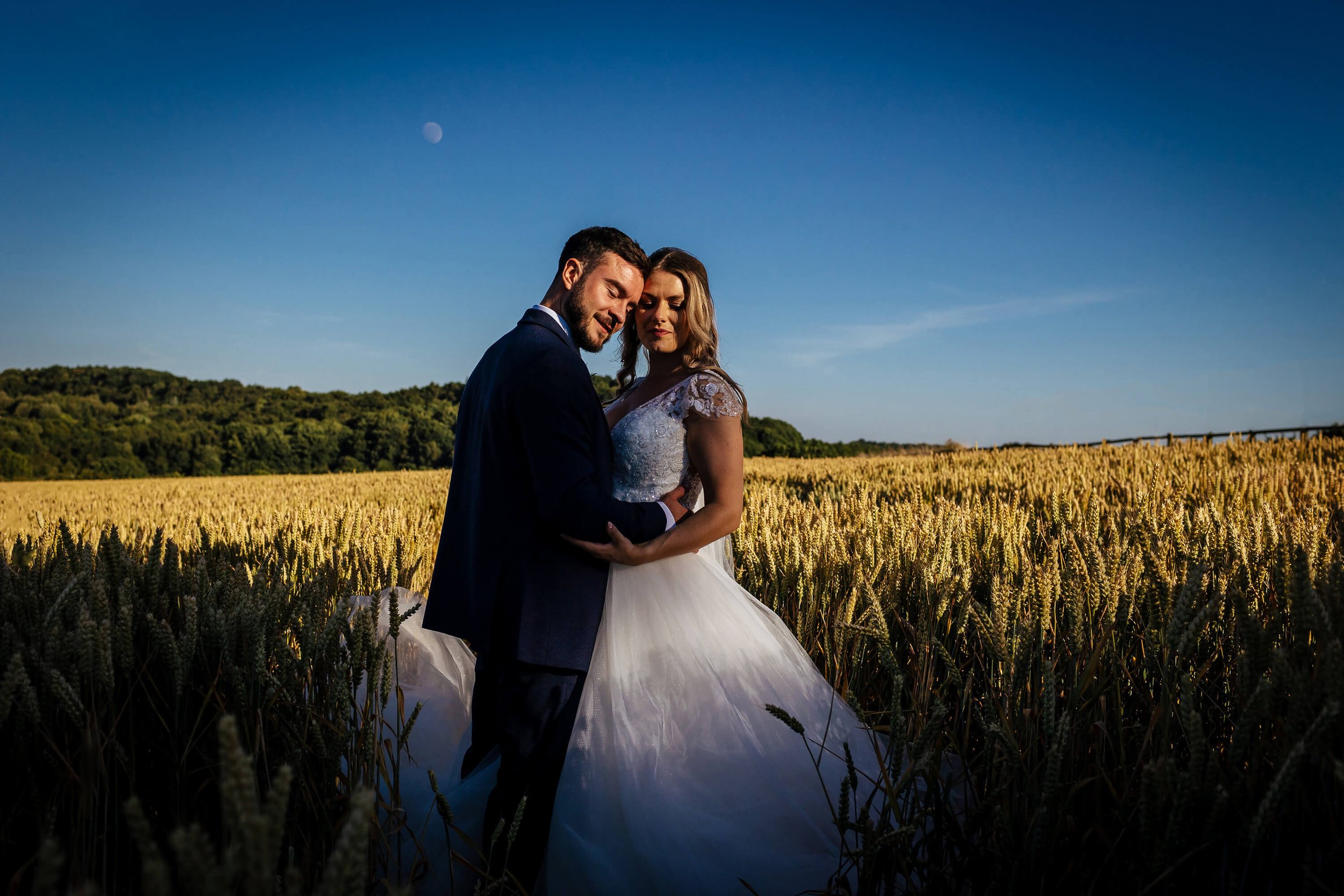 Bride and groom amongst the wheat fields at their wedding