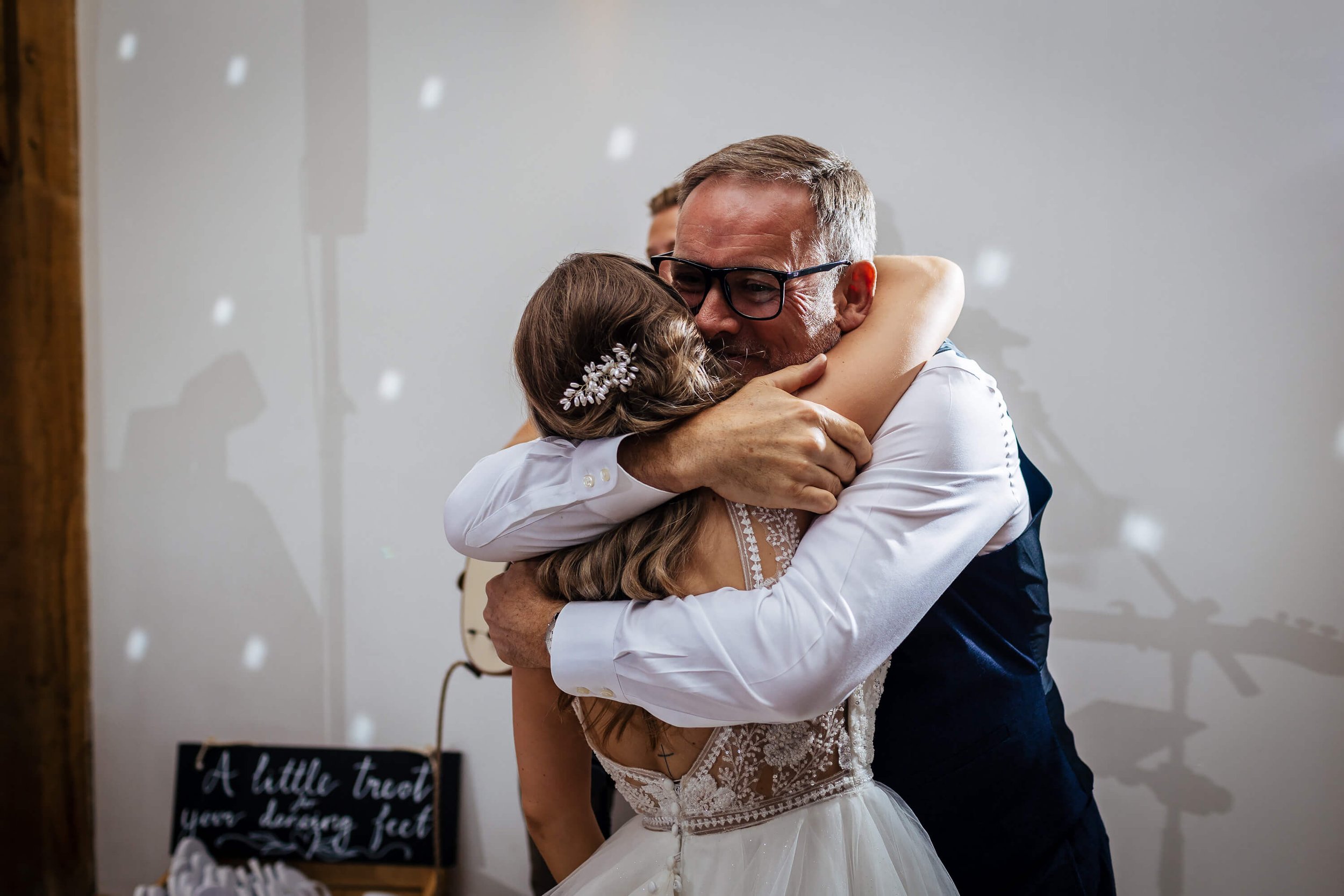 Bride and dad hugging on the dance floor at the wedding