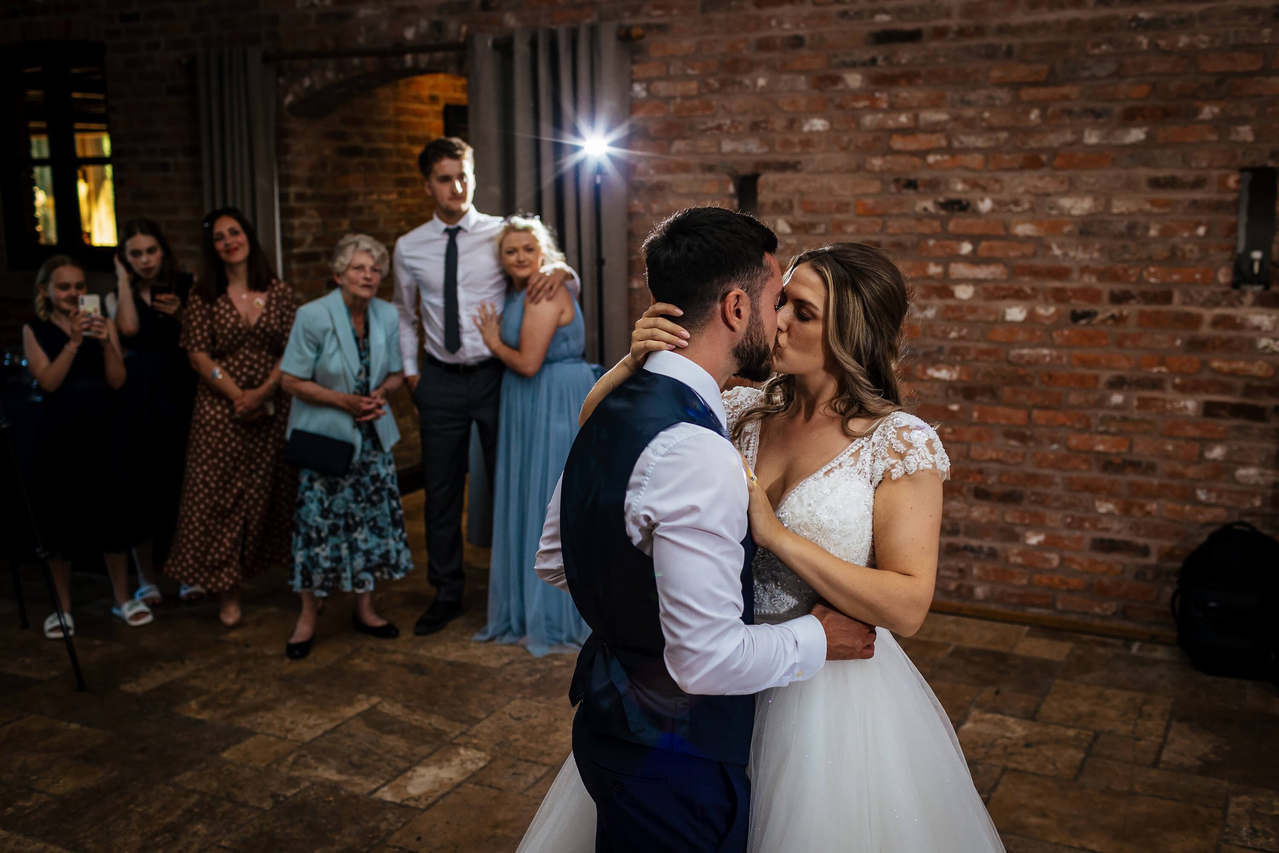 A kiss on the dance floor between bride and groom