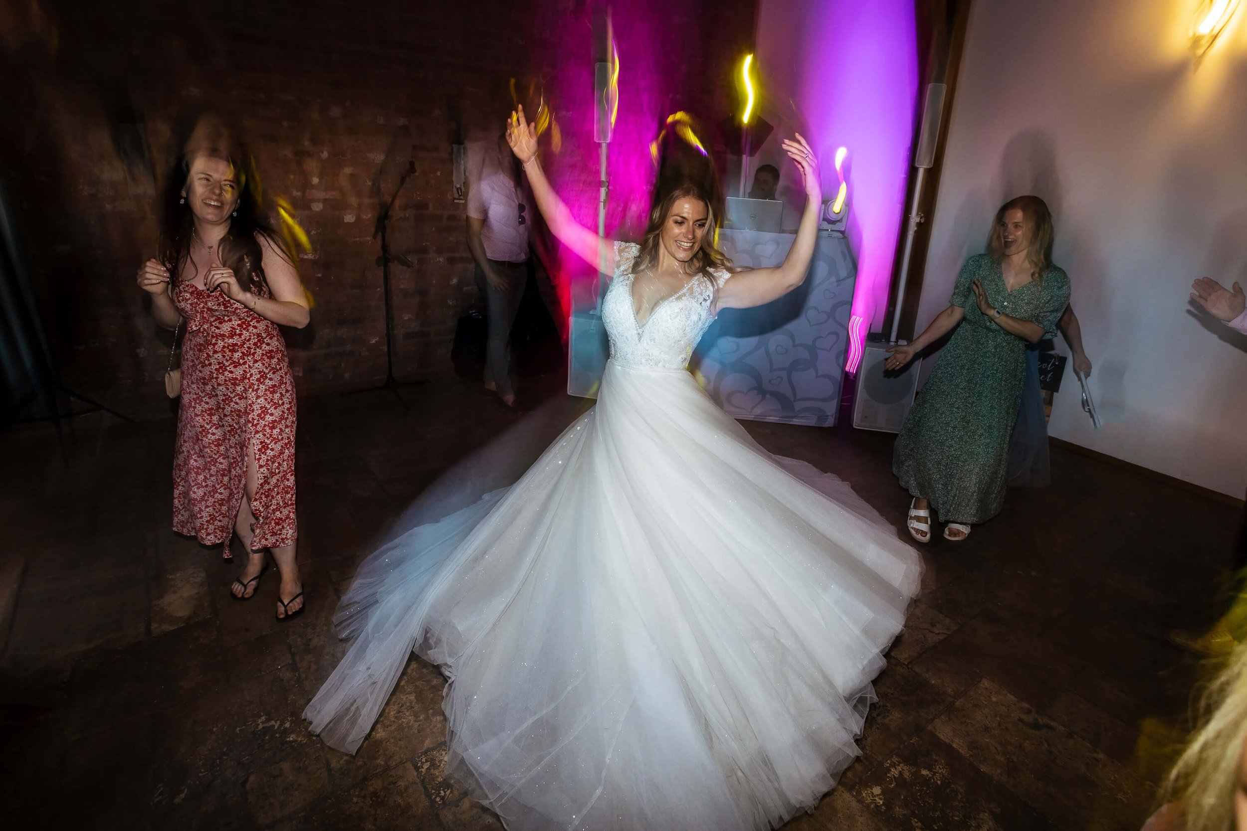 Bride swooshing her dress on the dance floor