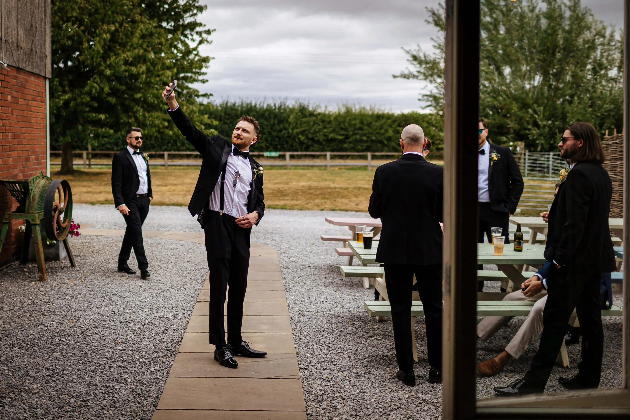 Groomsmen taking a selfie before the wedding ceremony