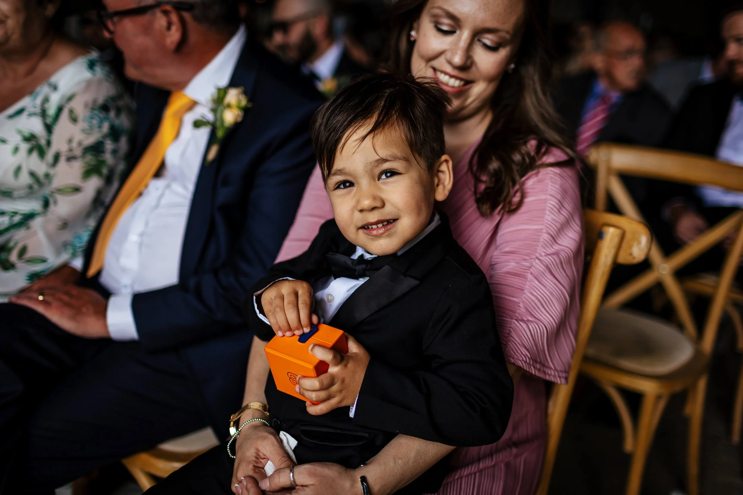 Young boy holds the wedding rings at the ceremony