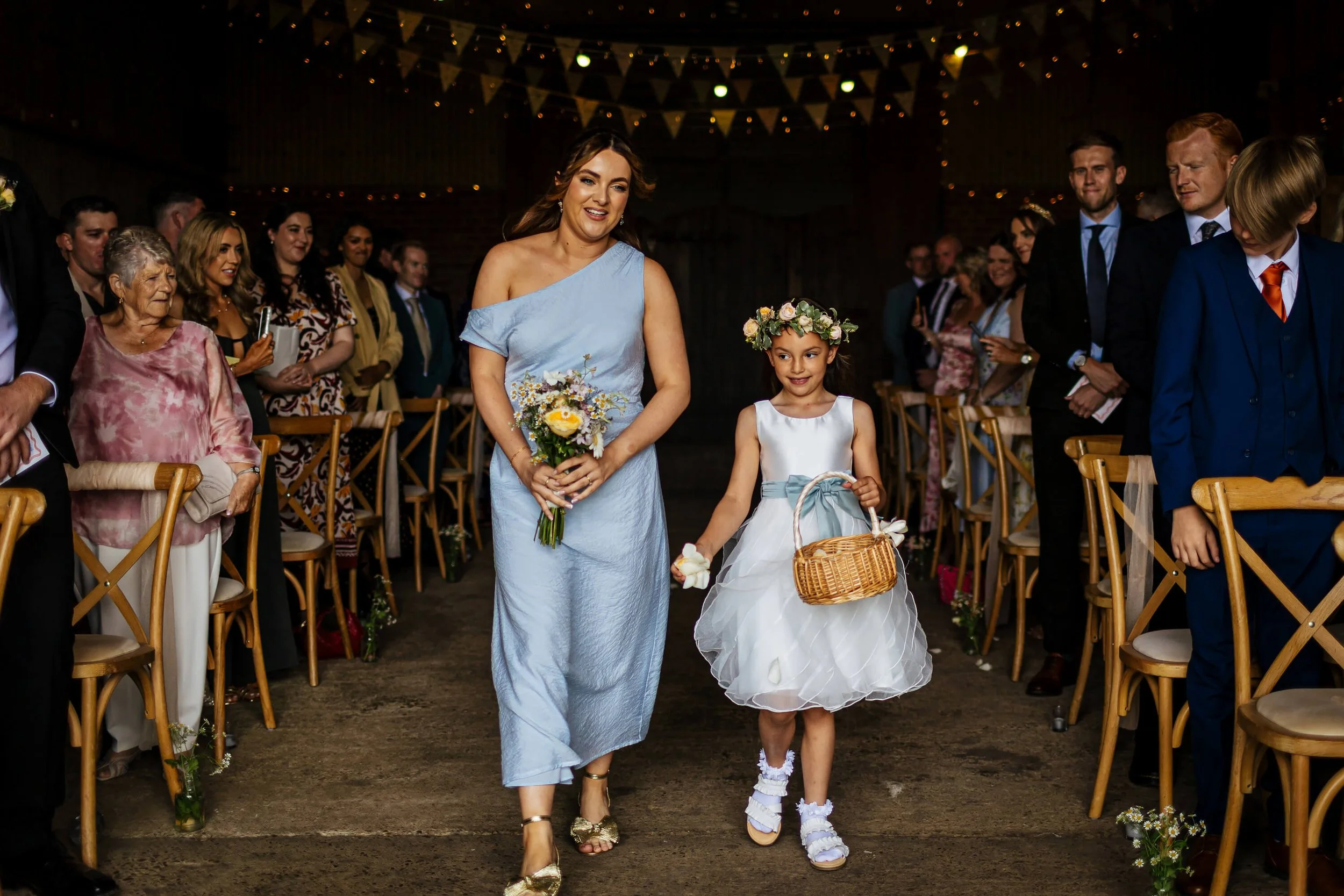 Bridesmaid walking down the aisle at a Berts Barrow wedding