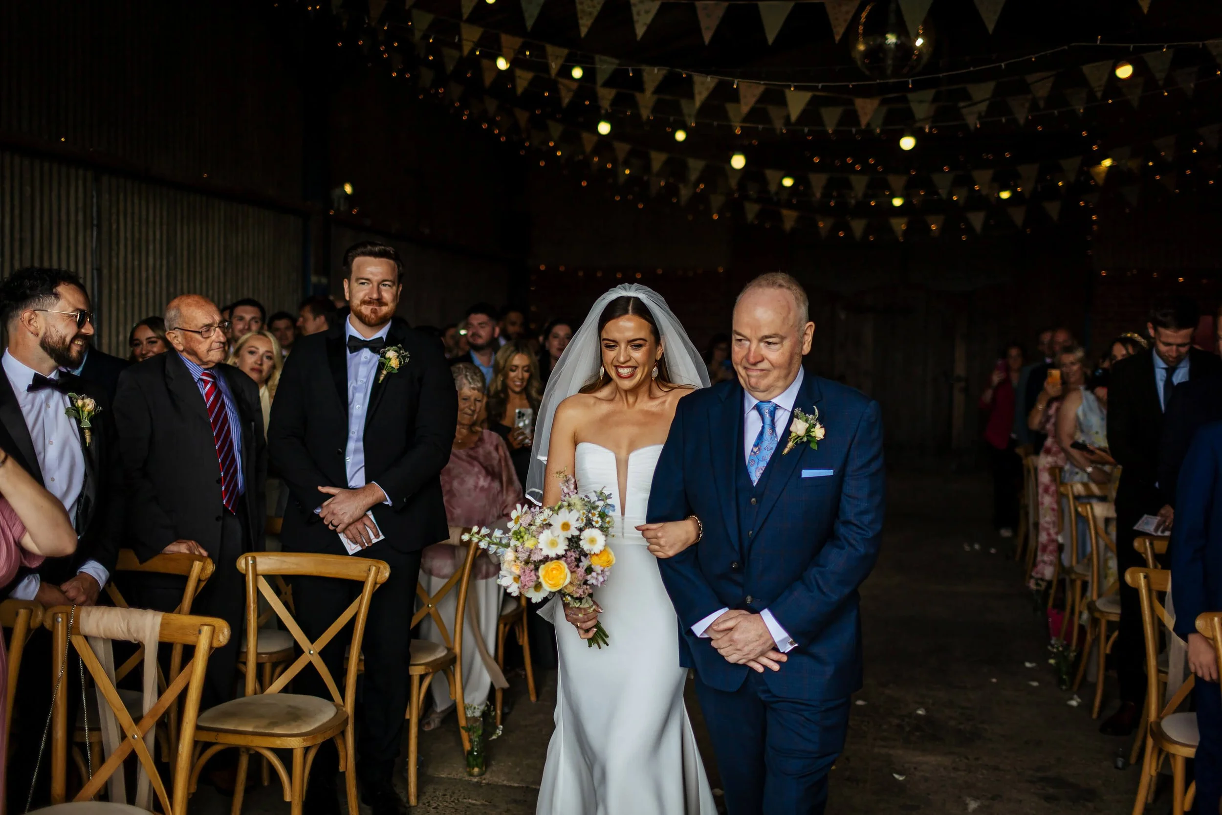 Bride and dad walking down the aisle at a wedding