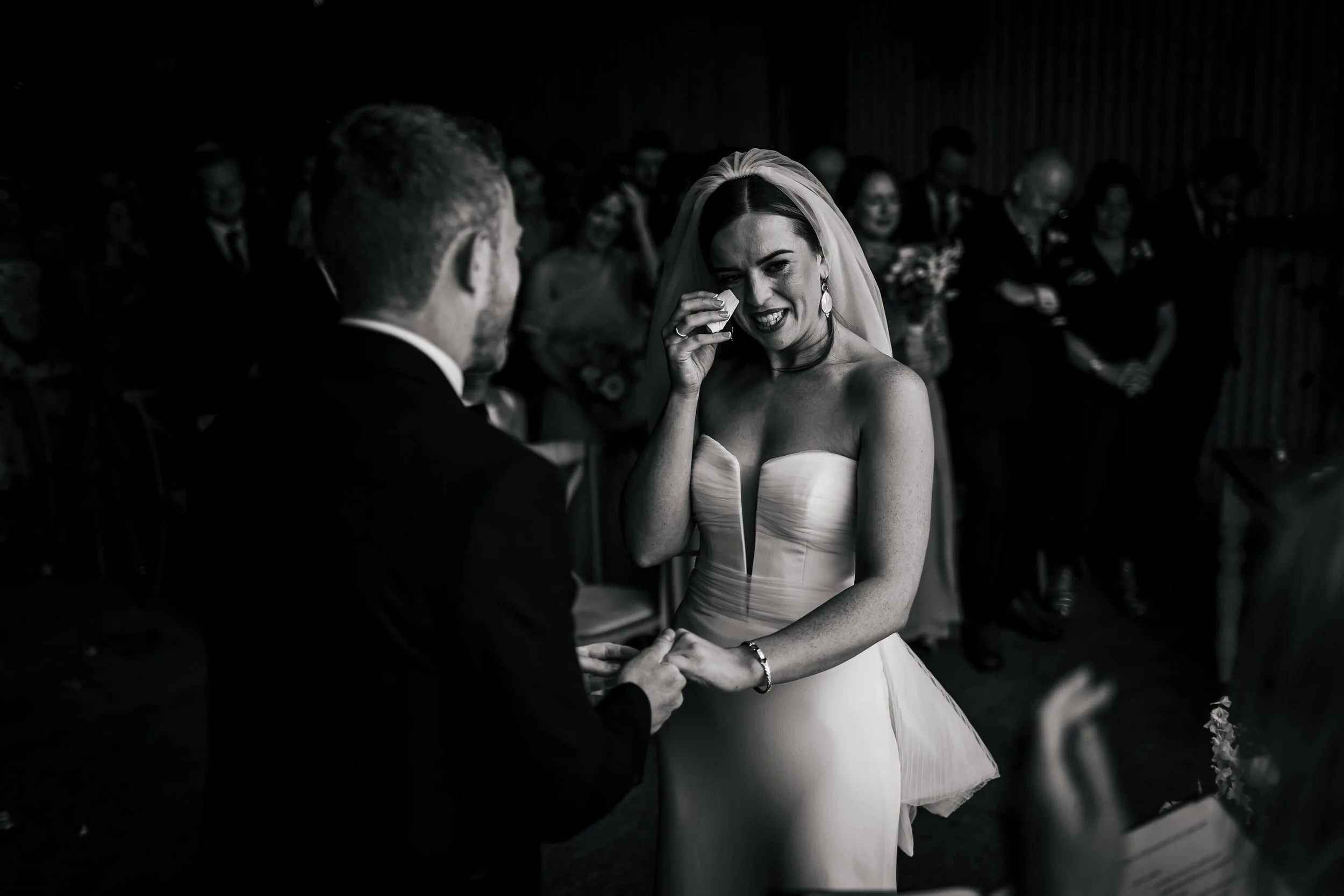 Bride wiping away the tears at her wedding ceremony