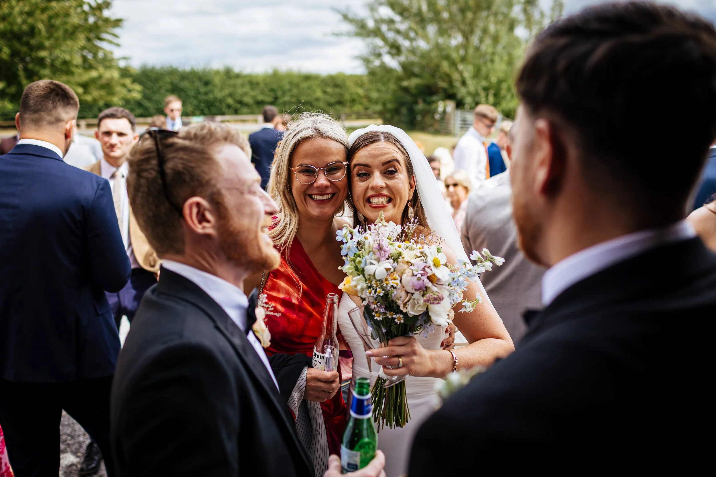 Bride and her friend pose for a photo at her wedding