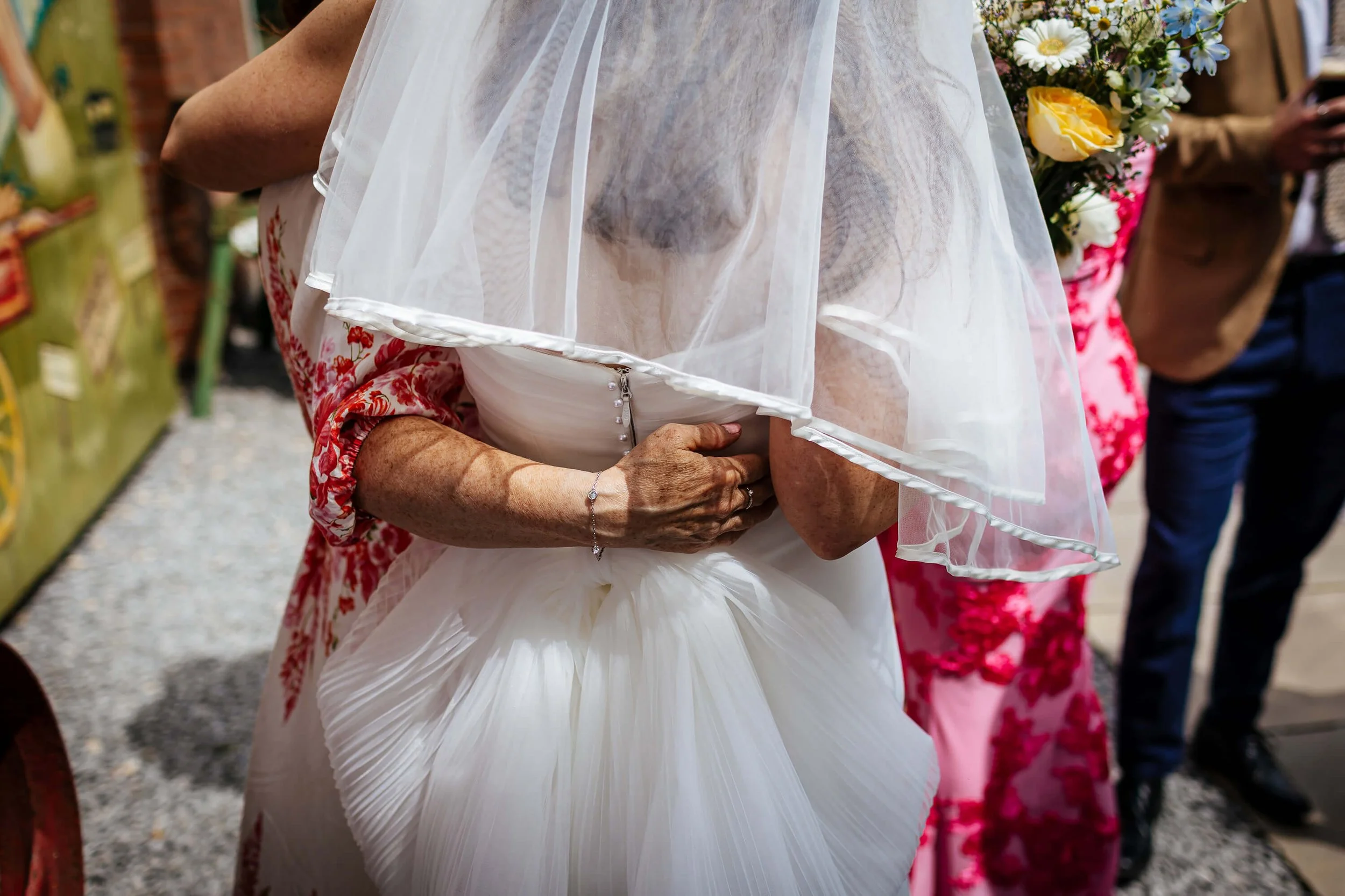Guest hugging the bride on her wedding day