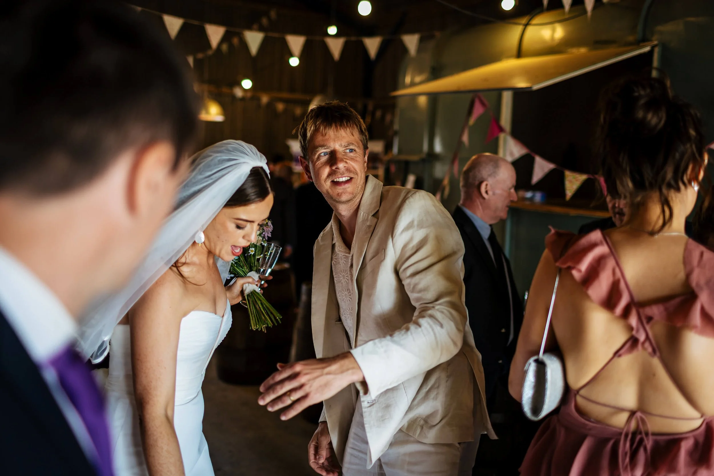 Wedding guests chatting with the bride