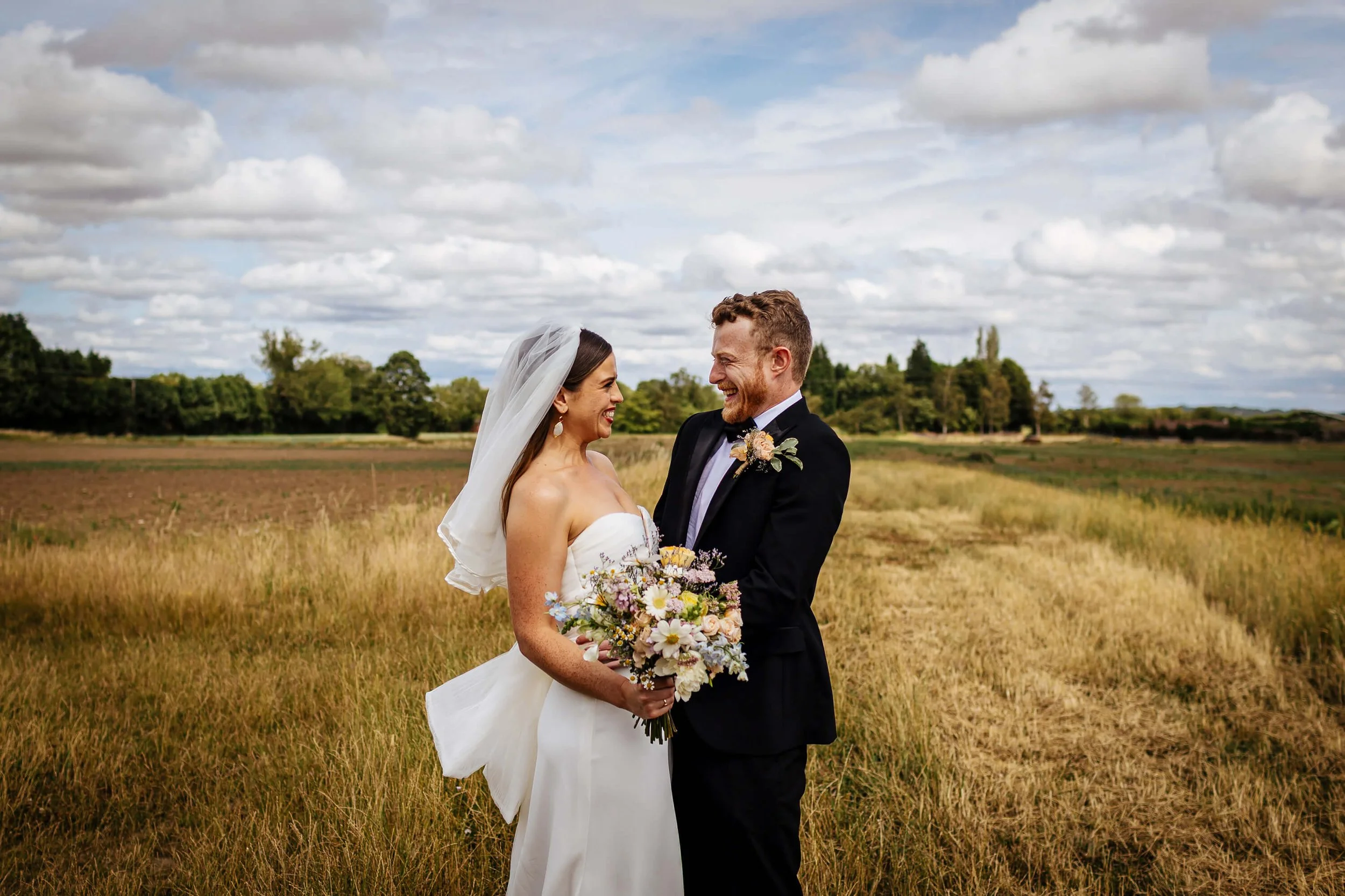 Couple portrait in the field at a Berts Barrow wedding