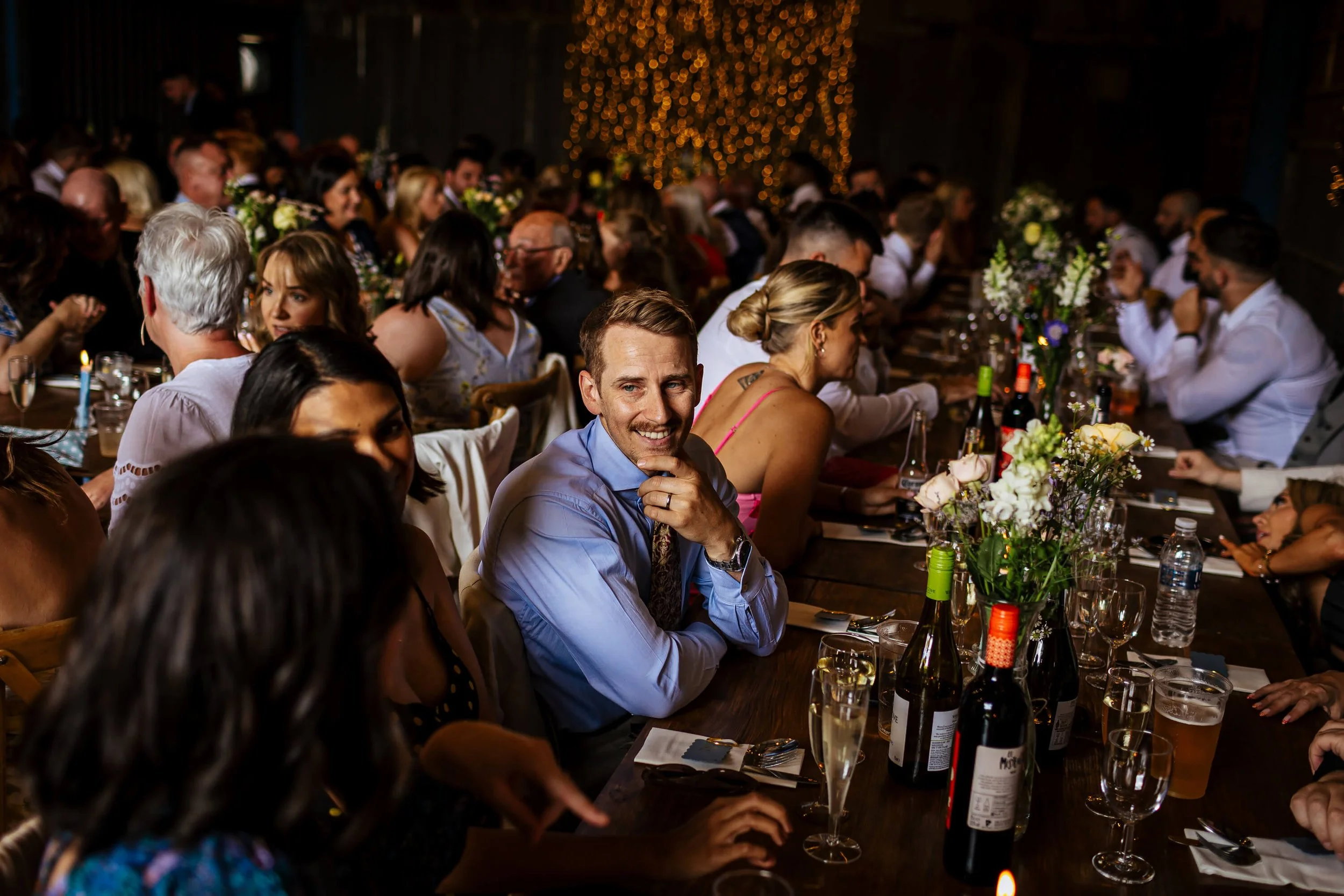 Guests sitting at the tables at a wedding