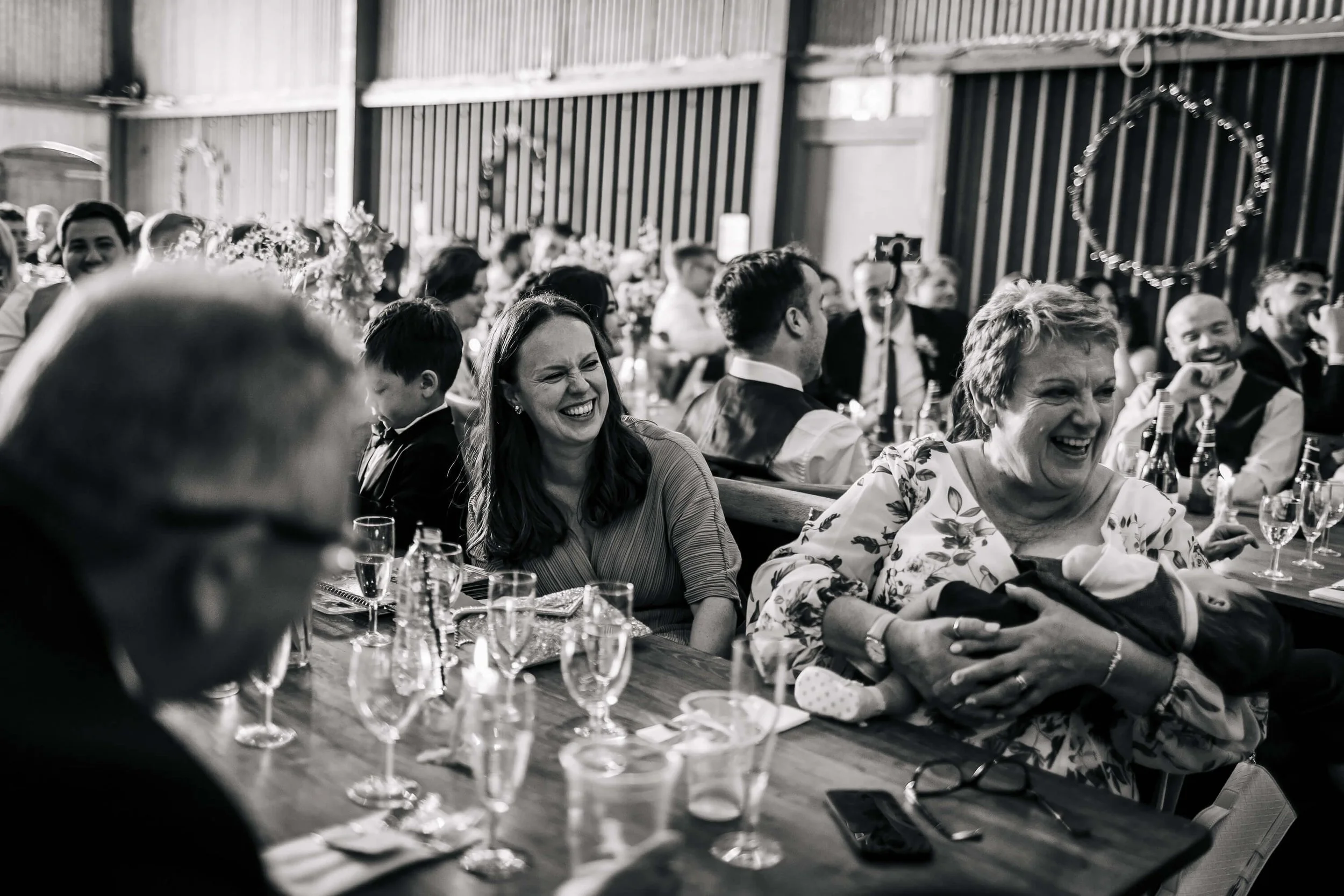 Wedding guests laughing at the speeches