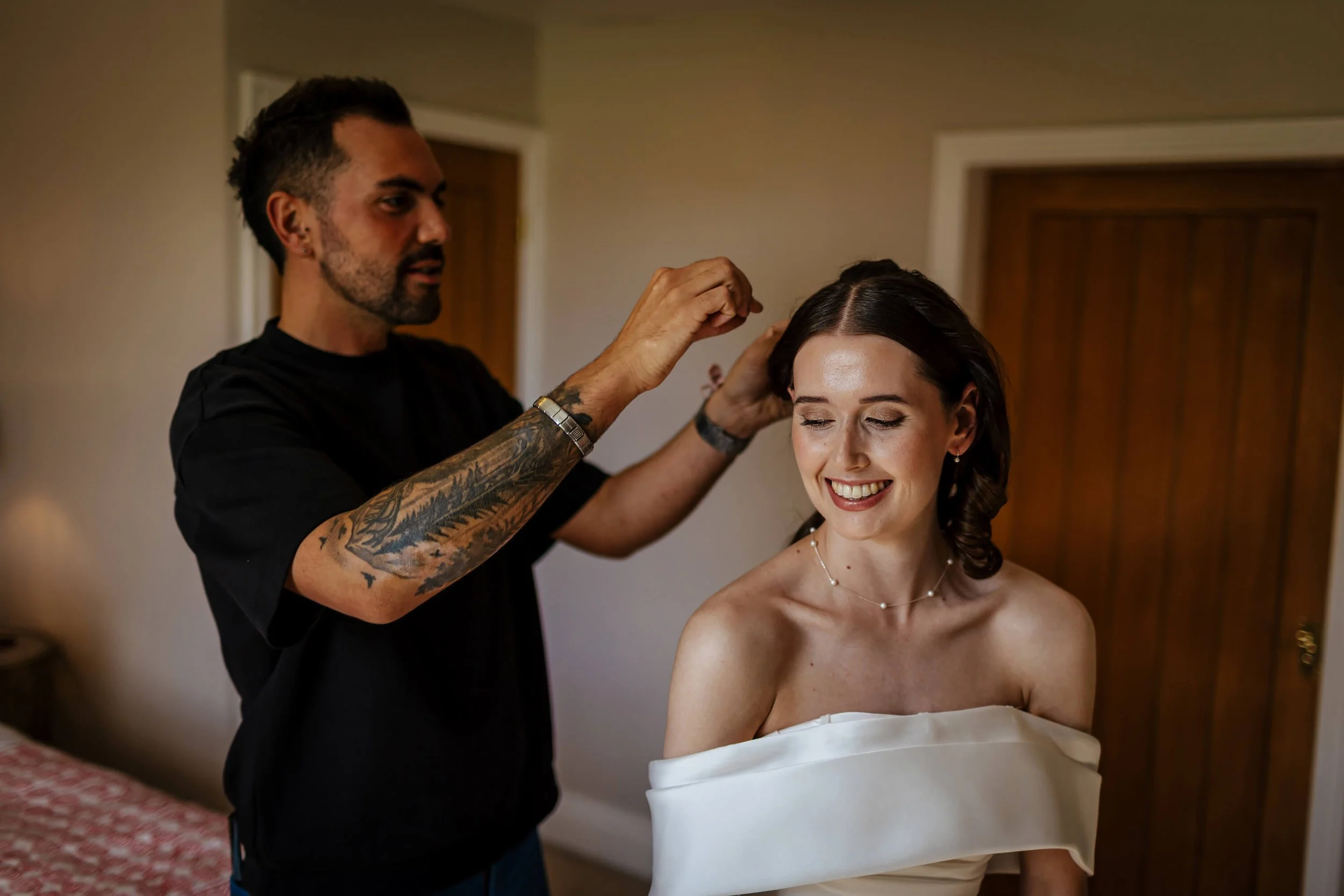 Stylist working on the bride's hair