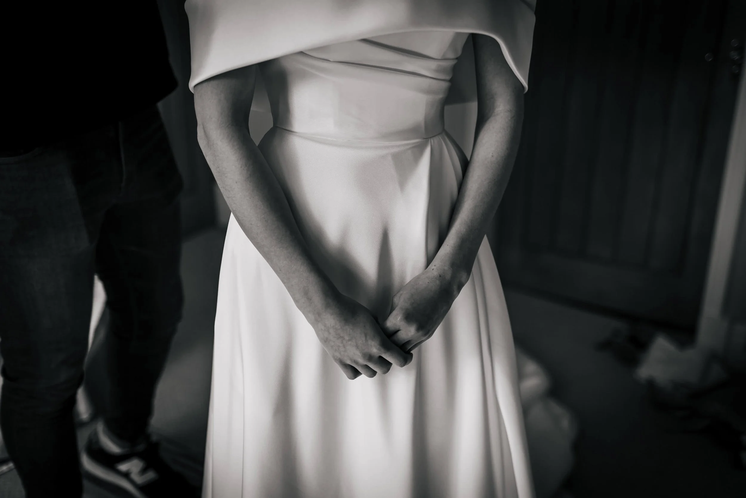 Bride gets into her dress on the morning of her wedding