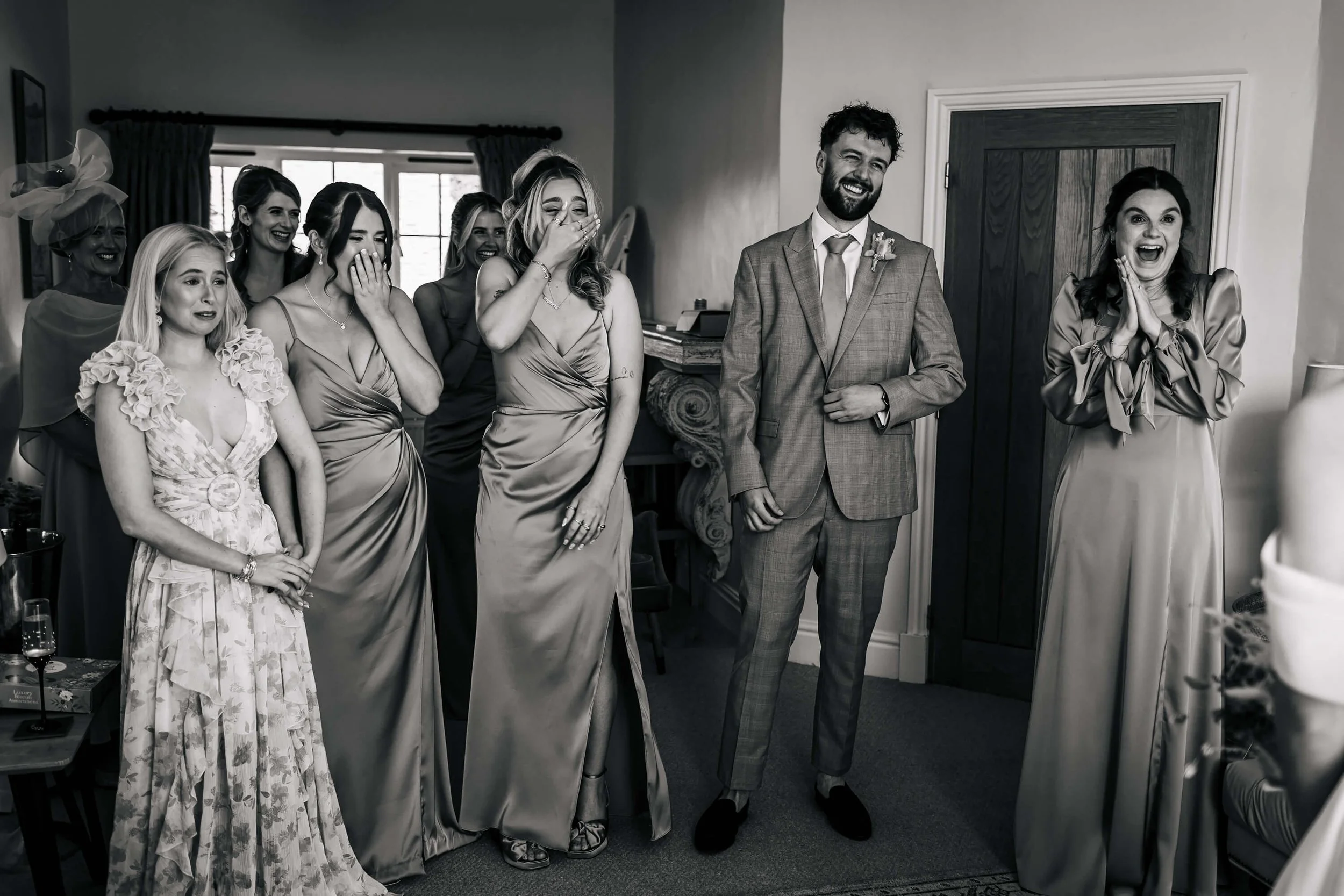 Bridesmaids see the bride for the first time in her dress