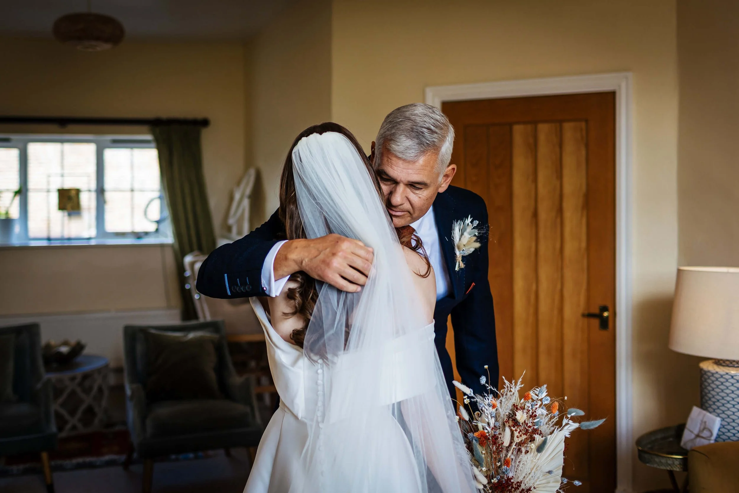 Bride and dad share a hug on her wedding day