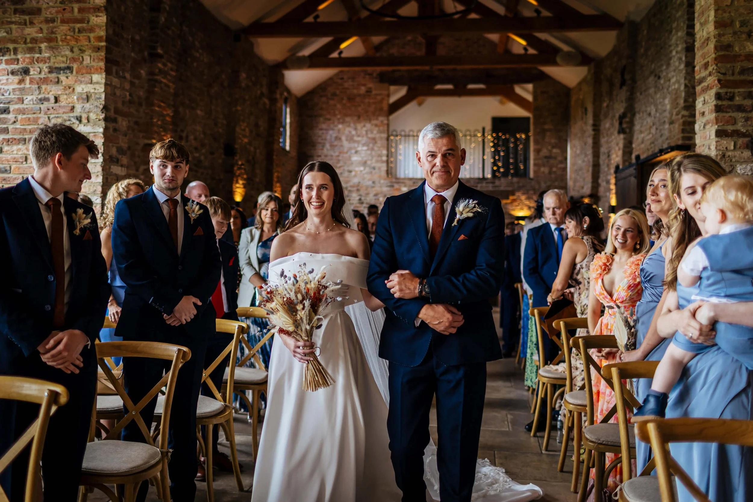 Bride and dad walk down the aisle to her wedding