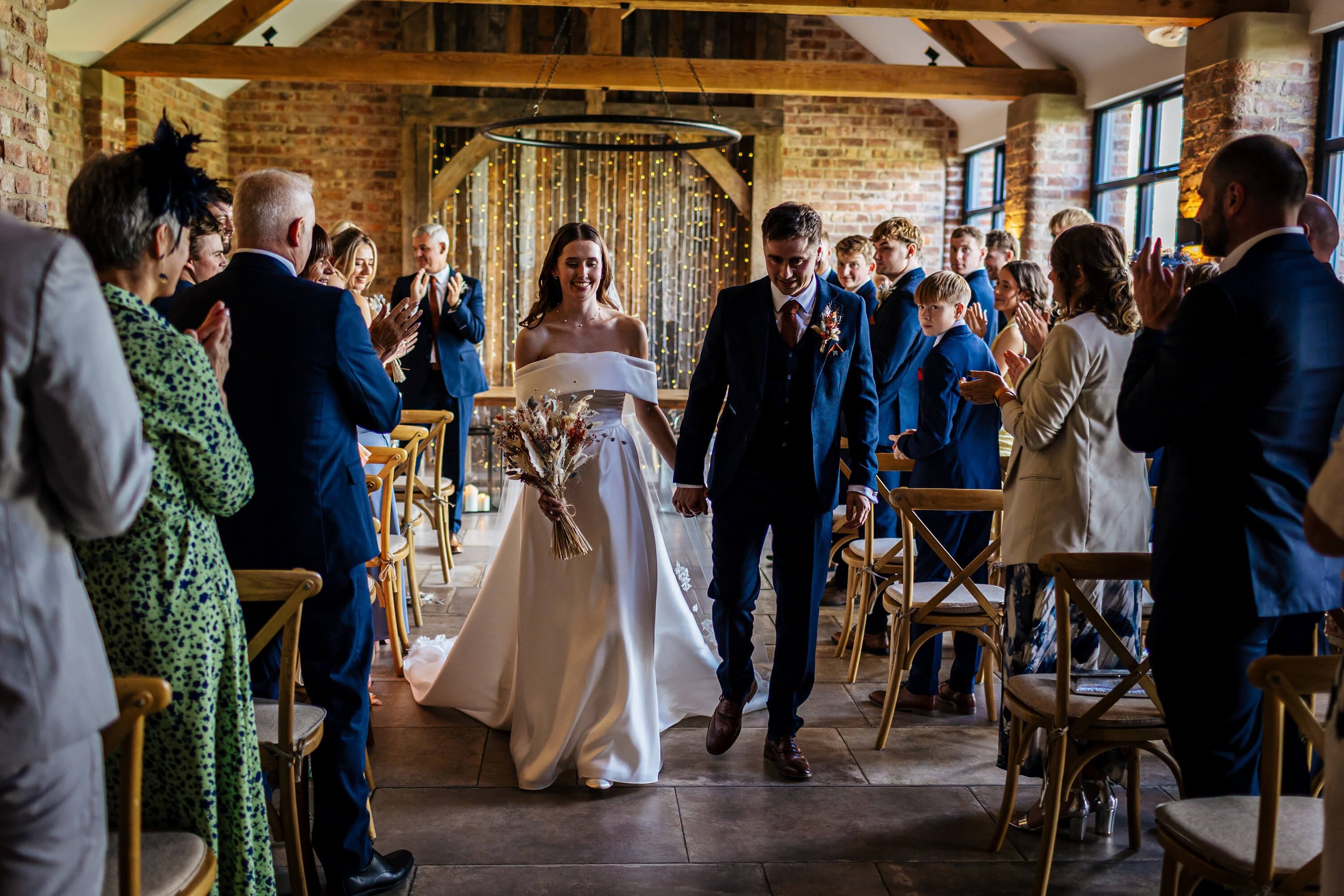 Bride and groom walk down the aisle as man and wife