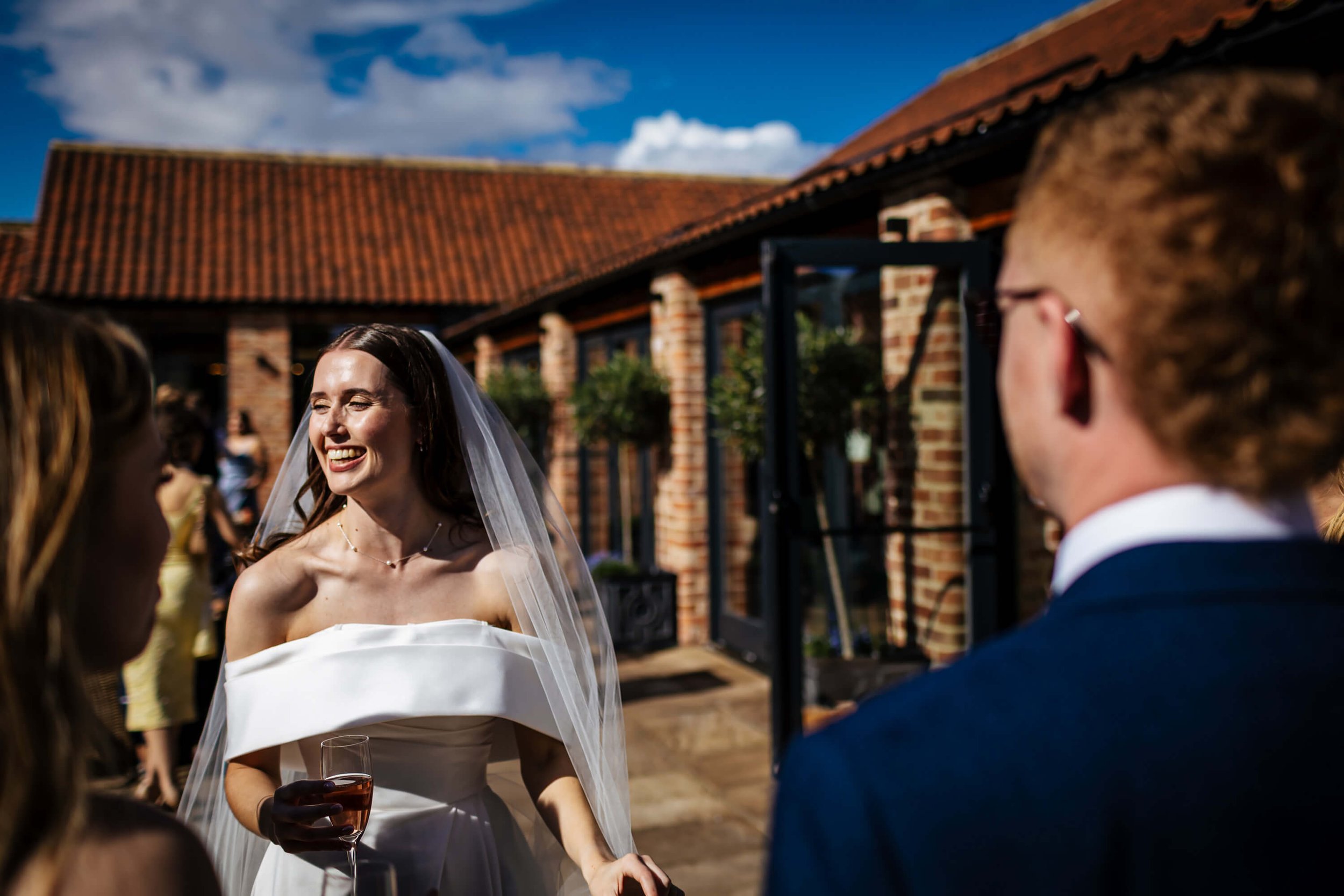Bride smiling in the sunshine at her wedding