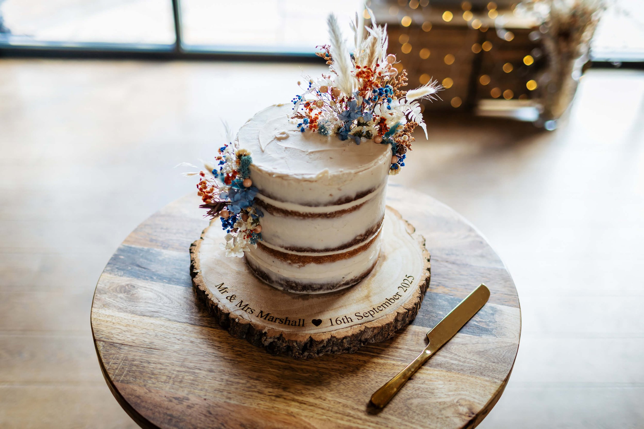 A beautiful wedding cake ready to be cut by the happy couple
