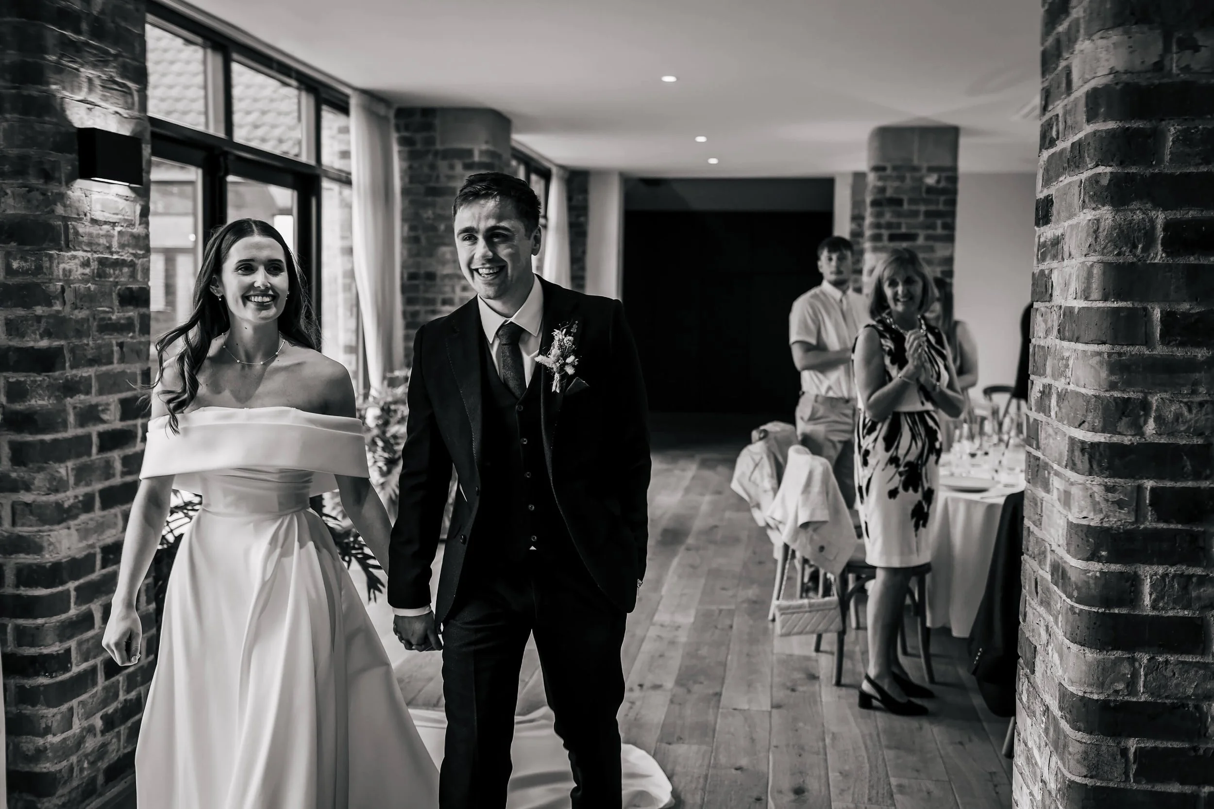 Bride and groom enter the wedding venue for their meal