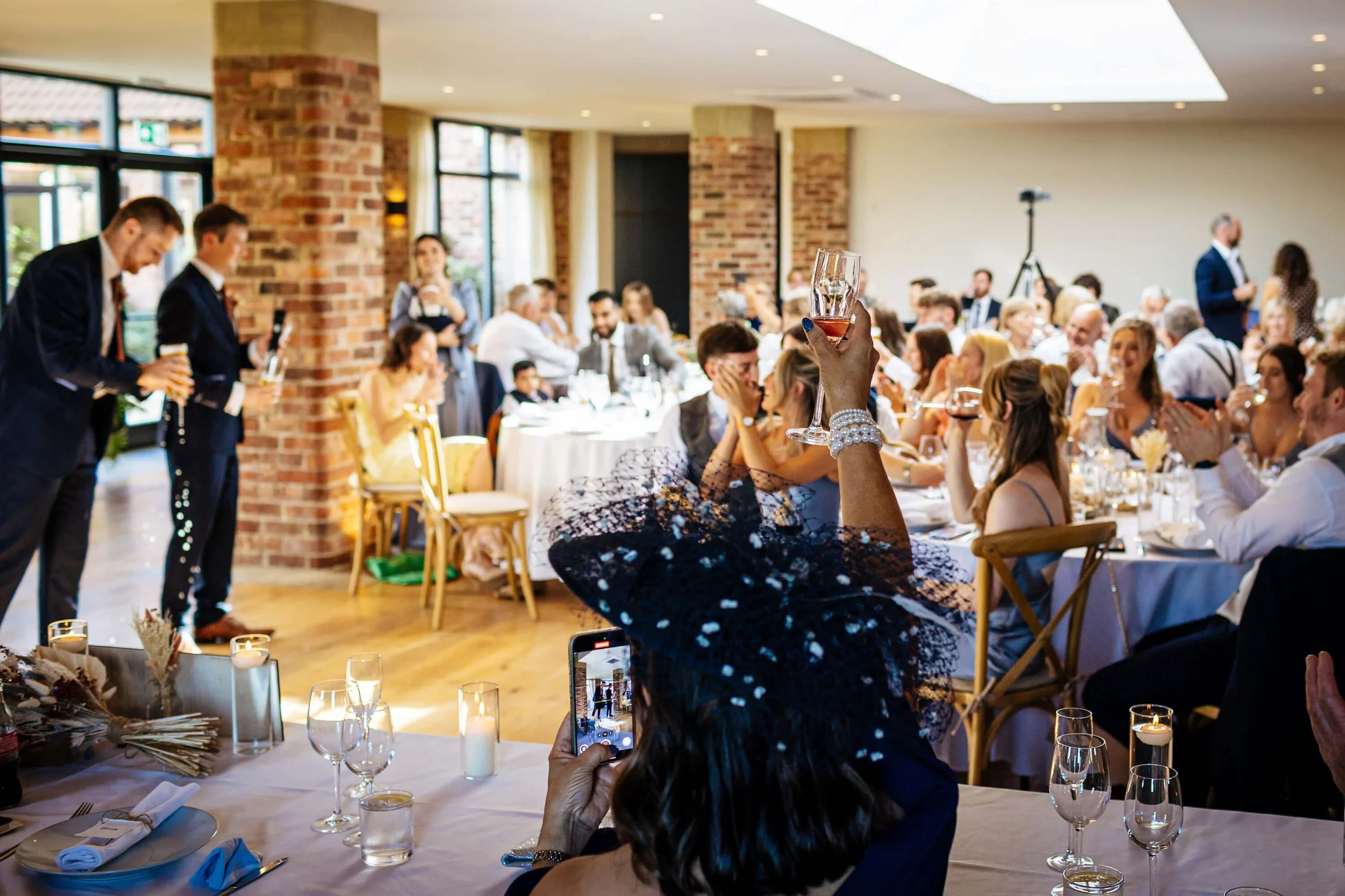 Wedding guests toasting the speeches