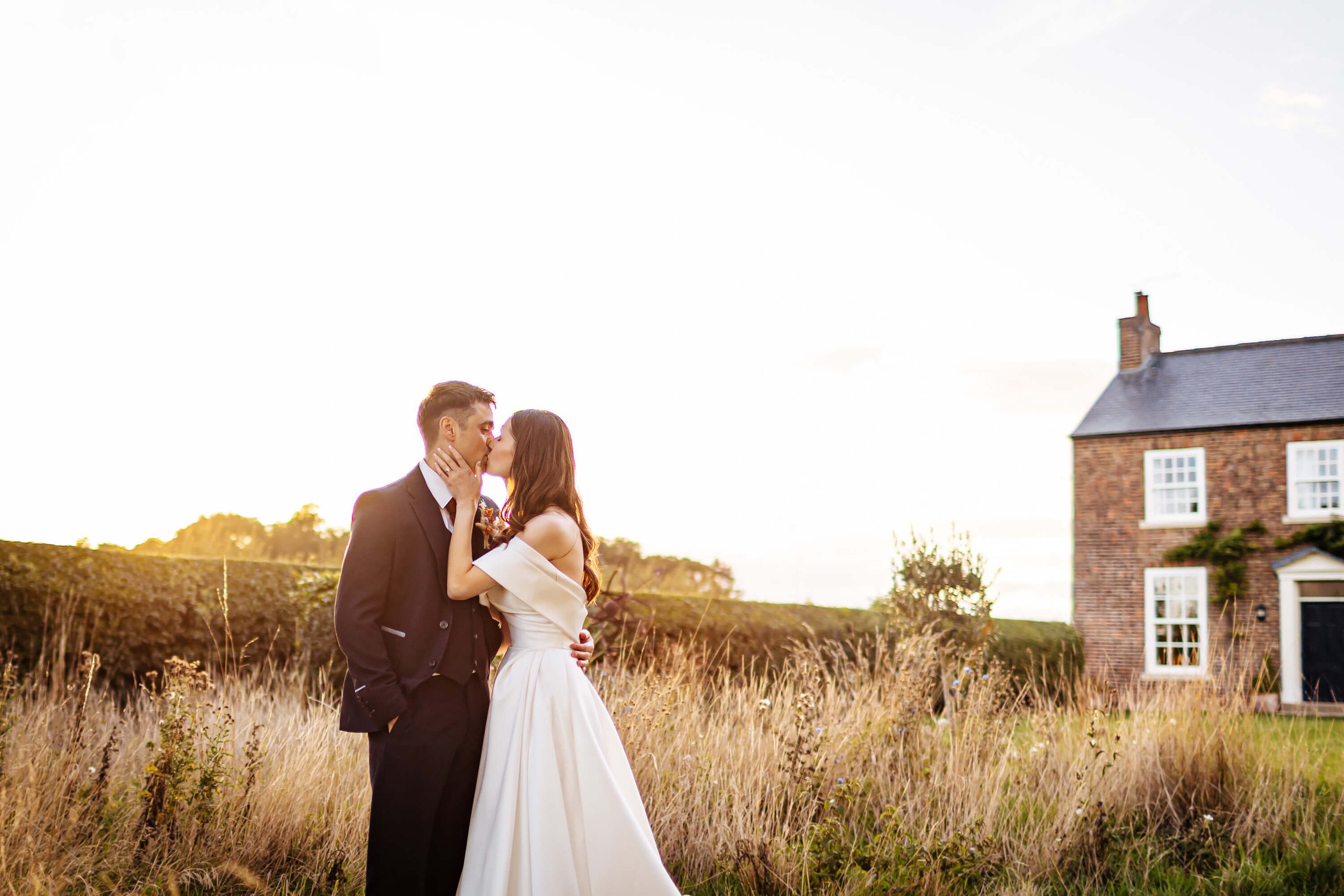 Bride and groom couple portrait against the setting sun