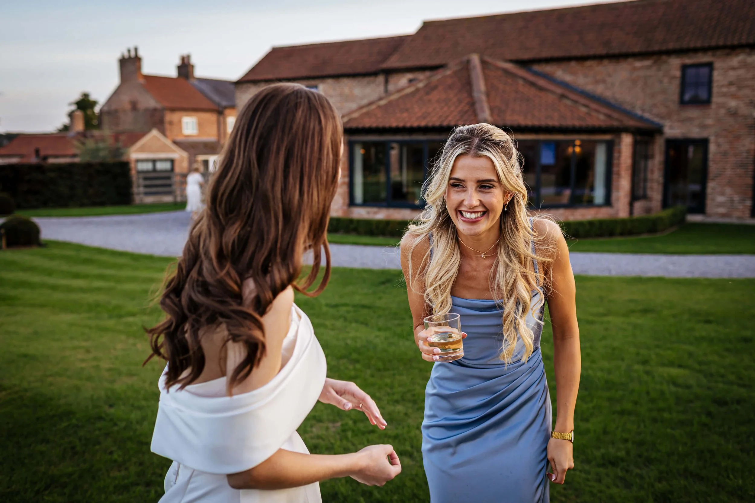 Bride and friend laughing on her wedding day