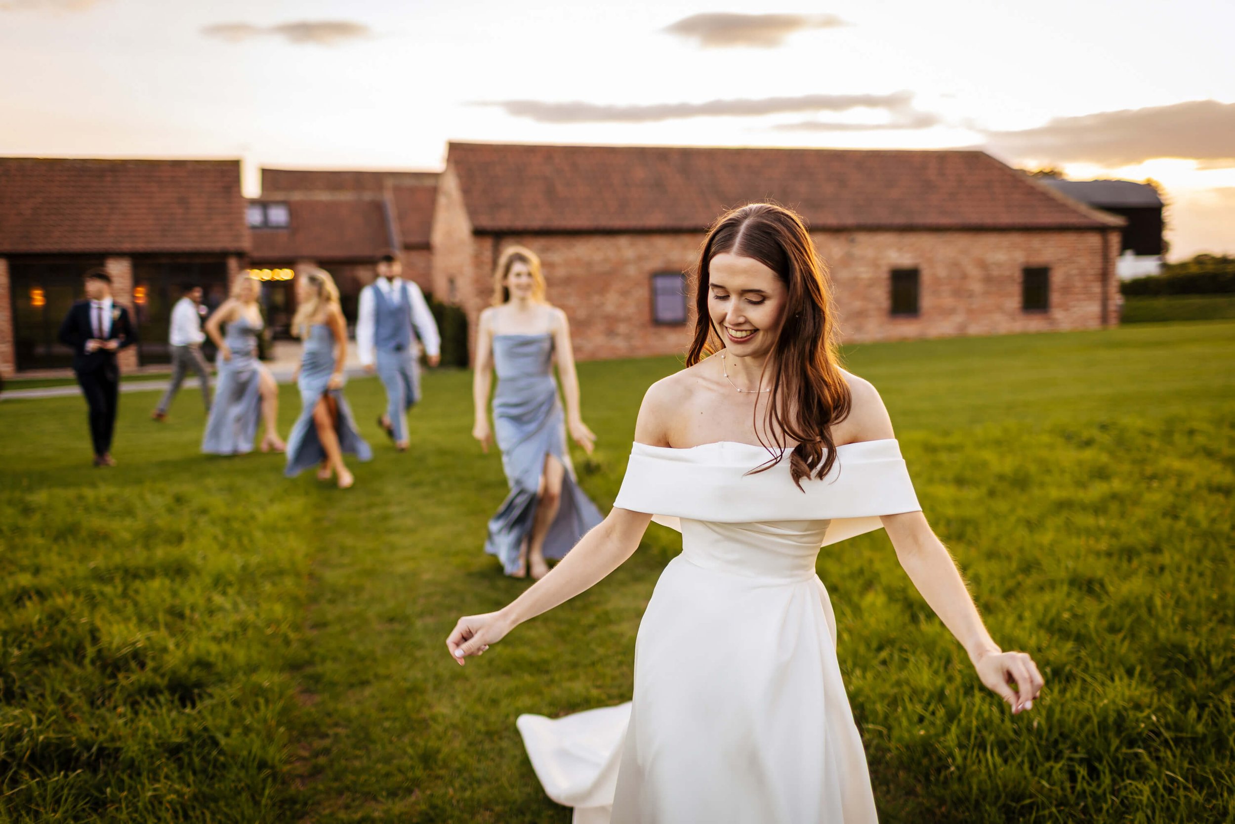 Bride walking through the grounds at Thirsk Lodge Barns