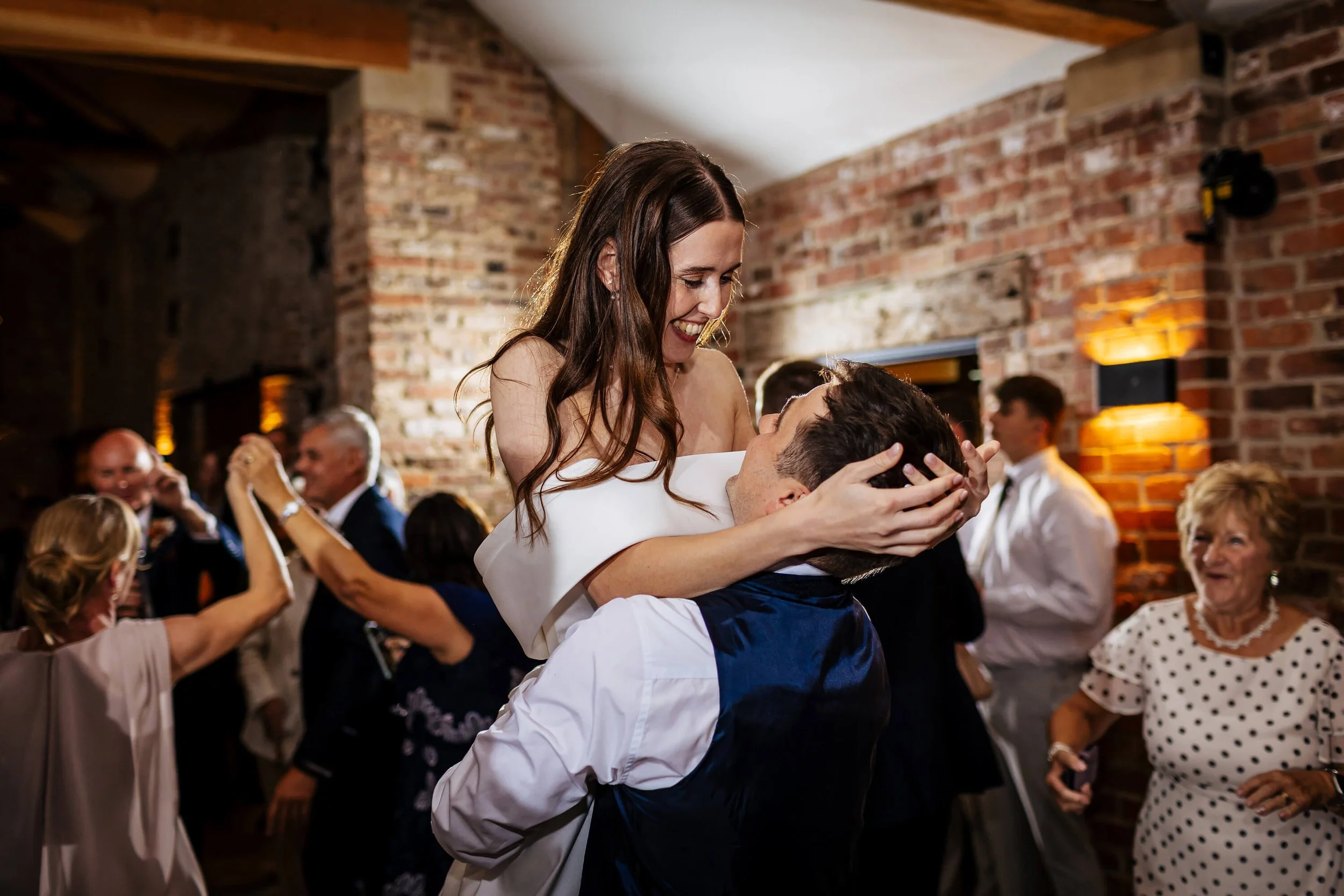 Groom lifts his bride during their first dance