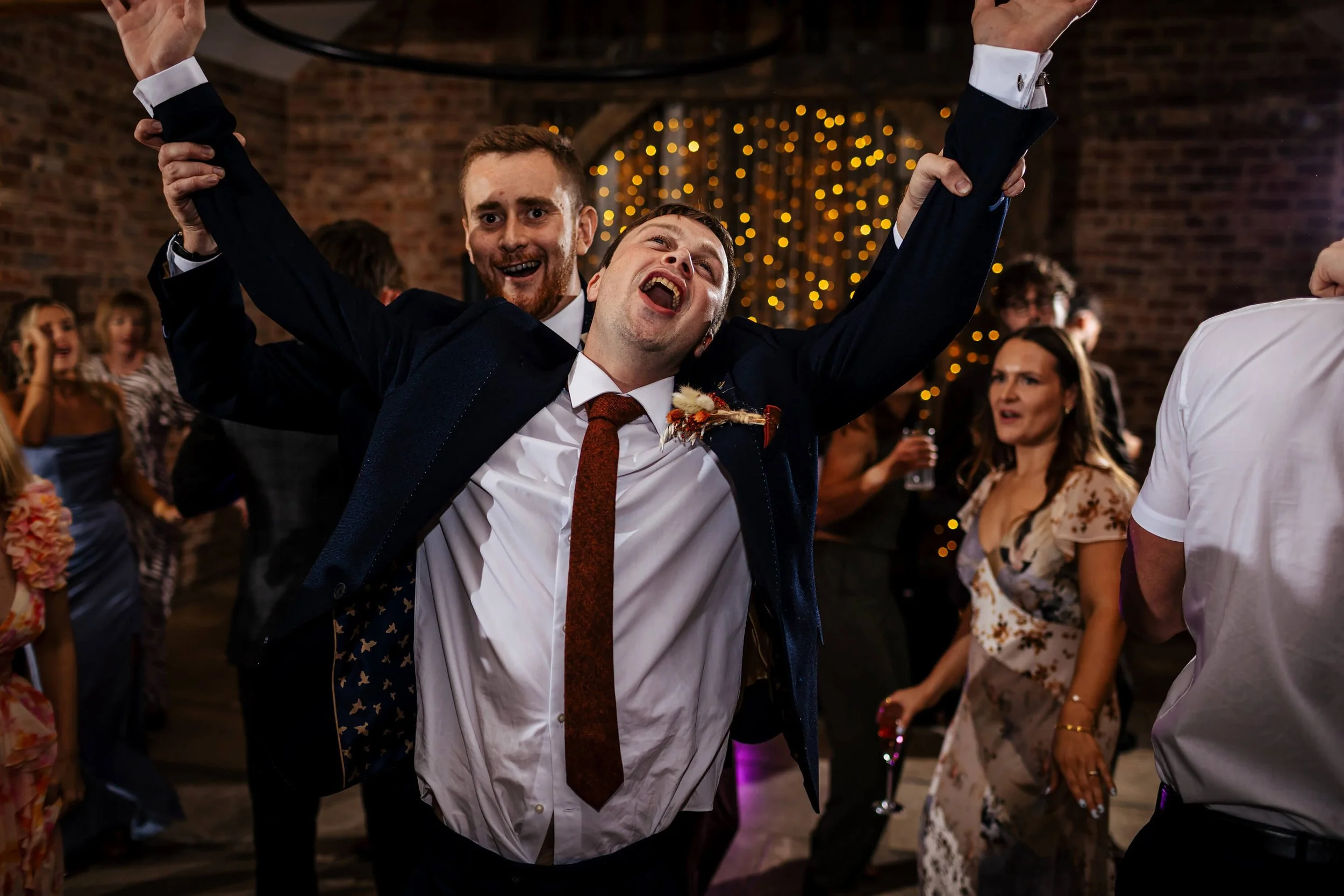 Groomsmen dancing at a wedding and being silly