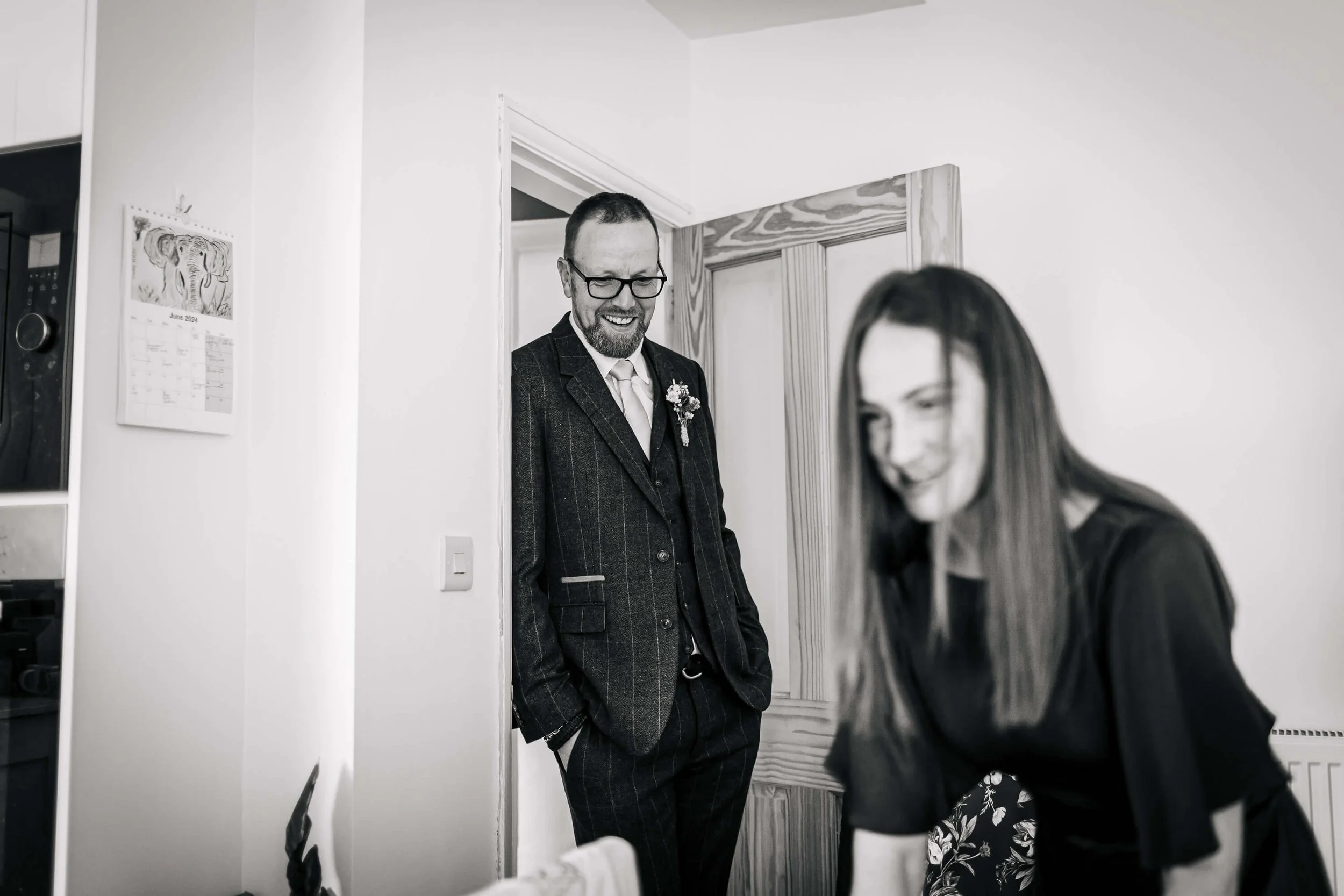 Father of the bride looks on as the girls get ready