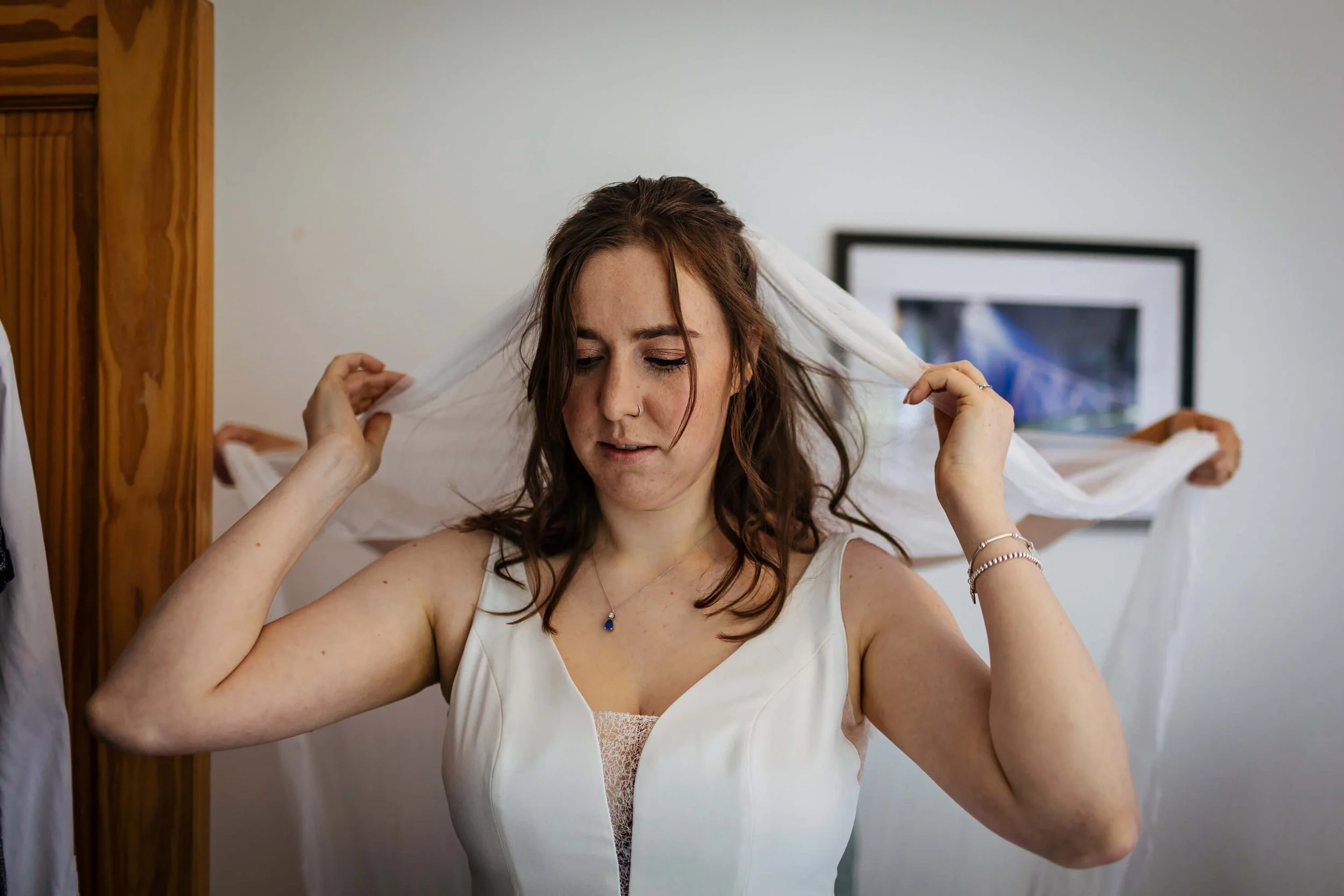 Bride playing with her veil on her wedding morning