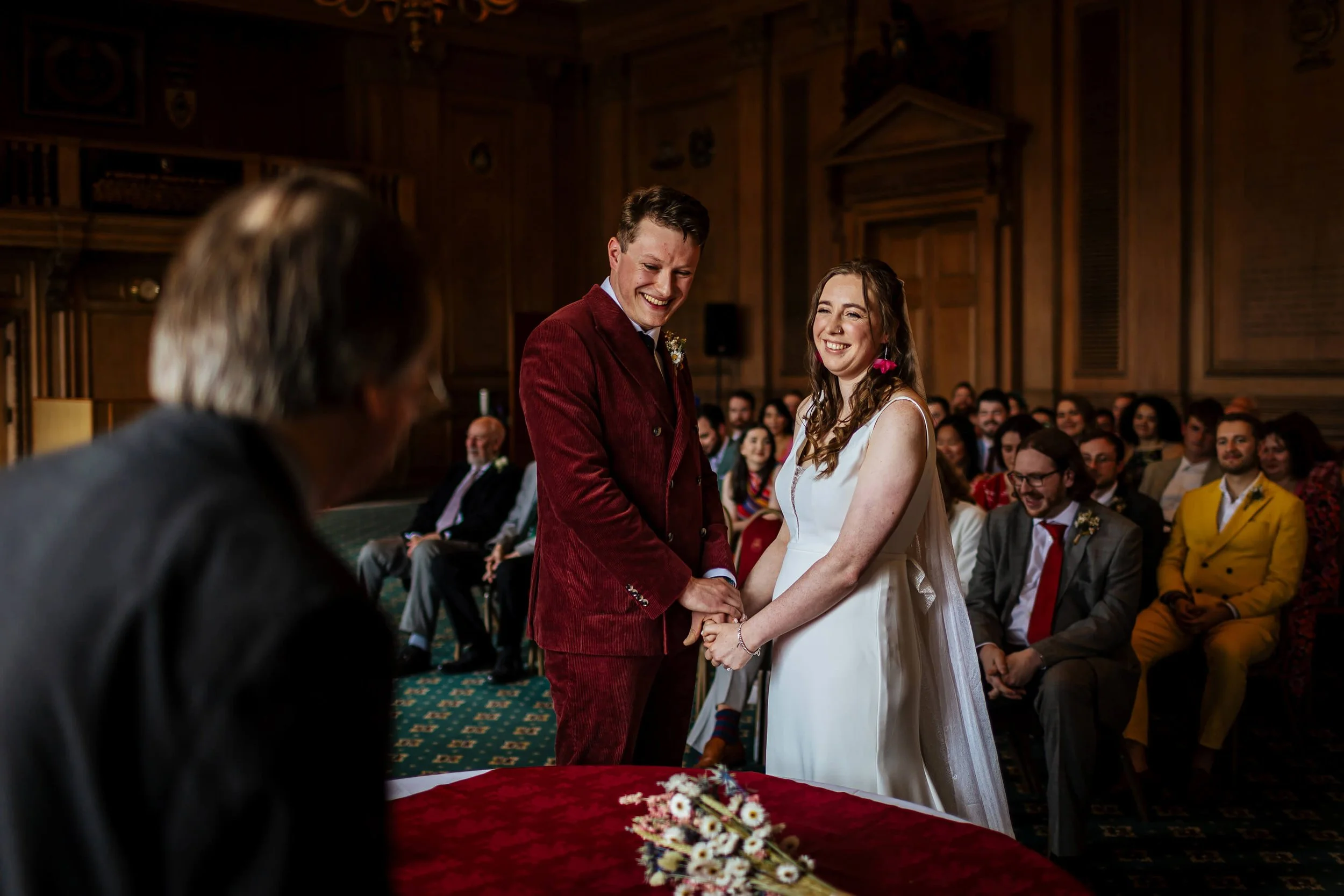 Bride and groom holding hands during their wedding ceremony