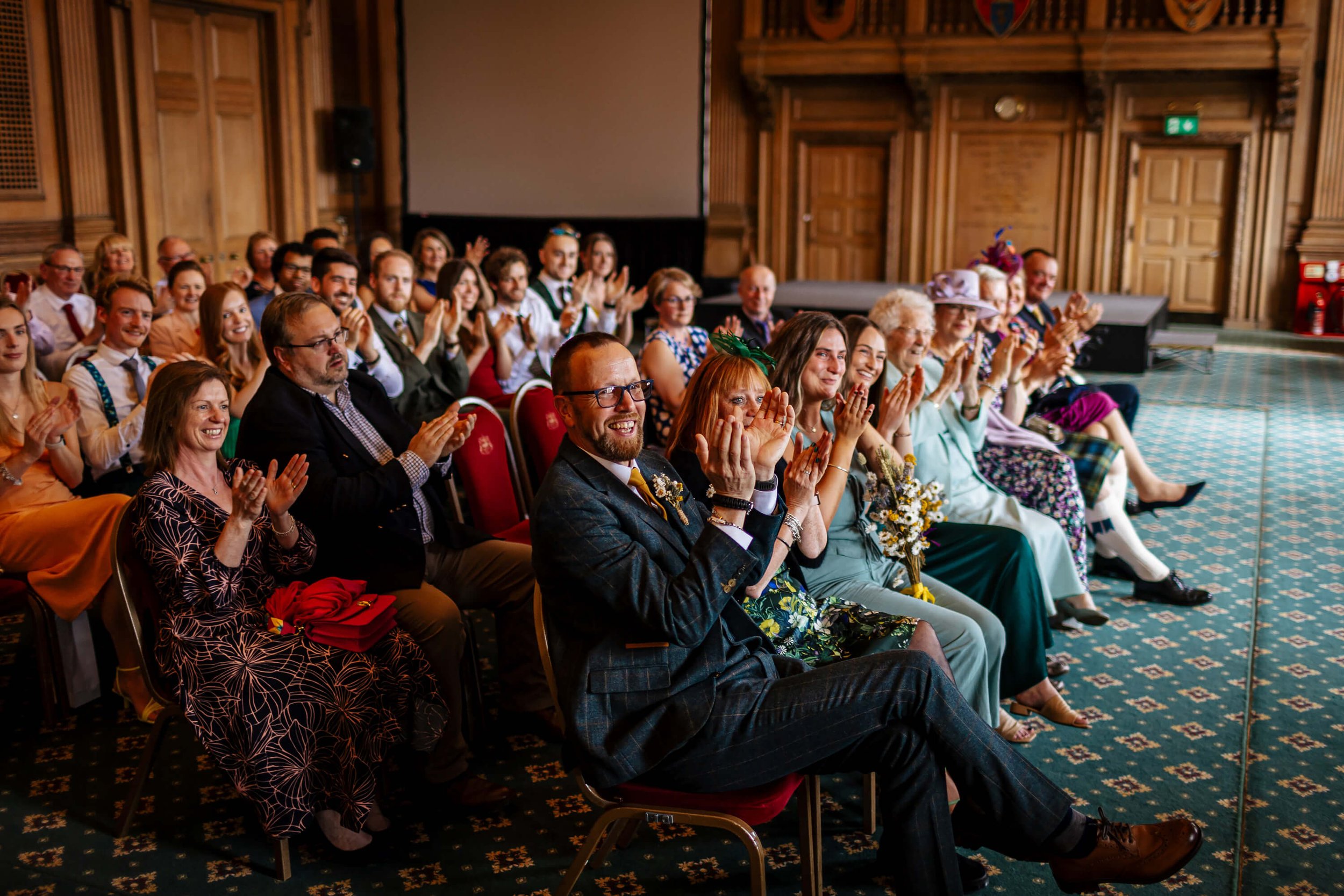 Wedding guests cheer during the ceremony