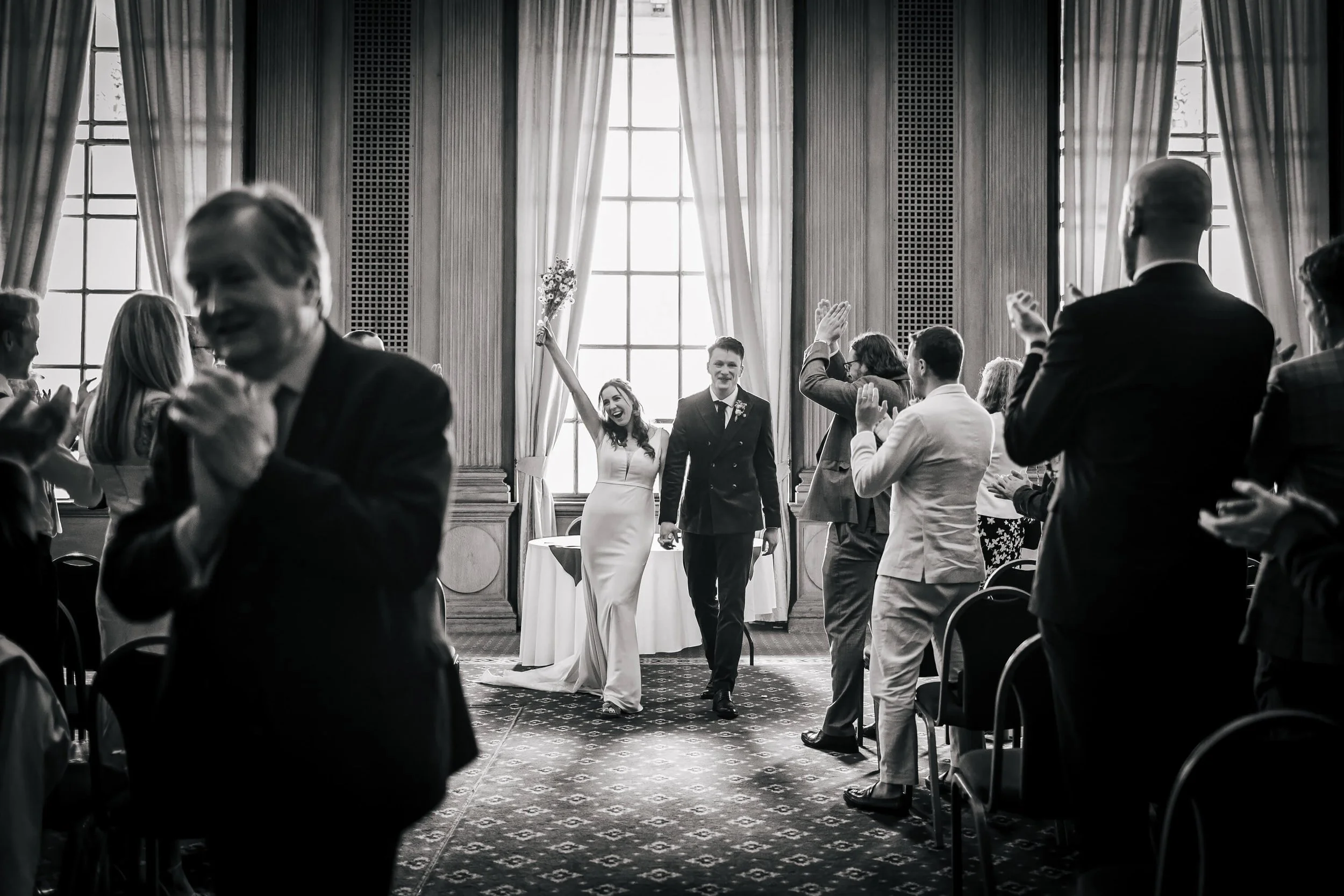 Bride and groom walk down the aisle at their wedding in Leeds