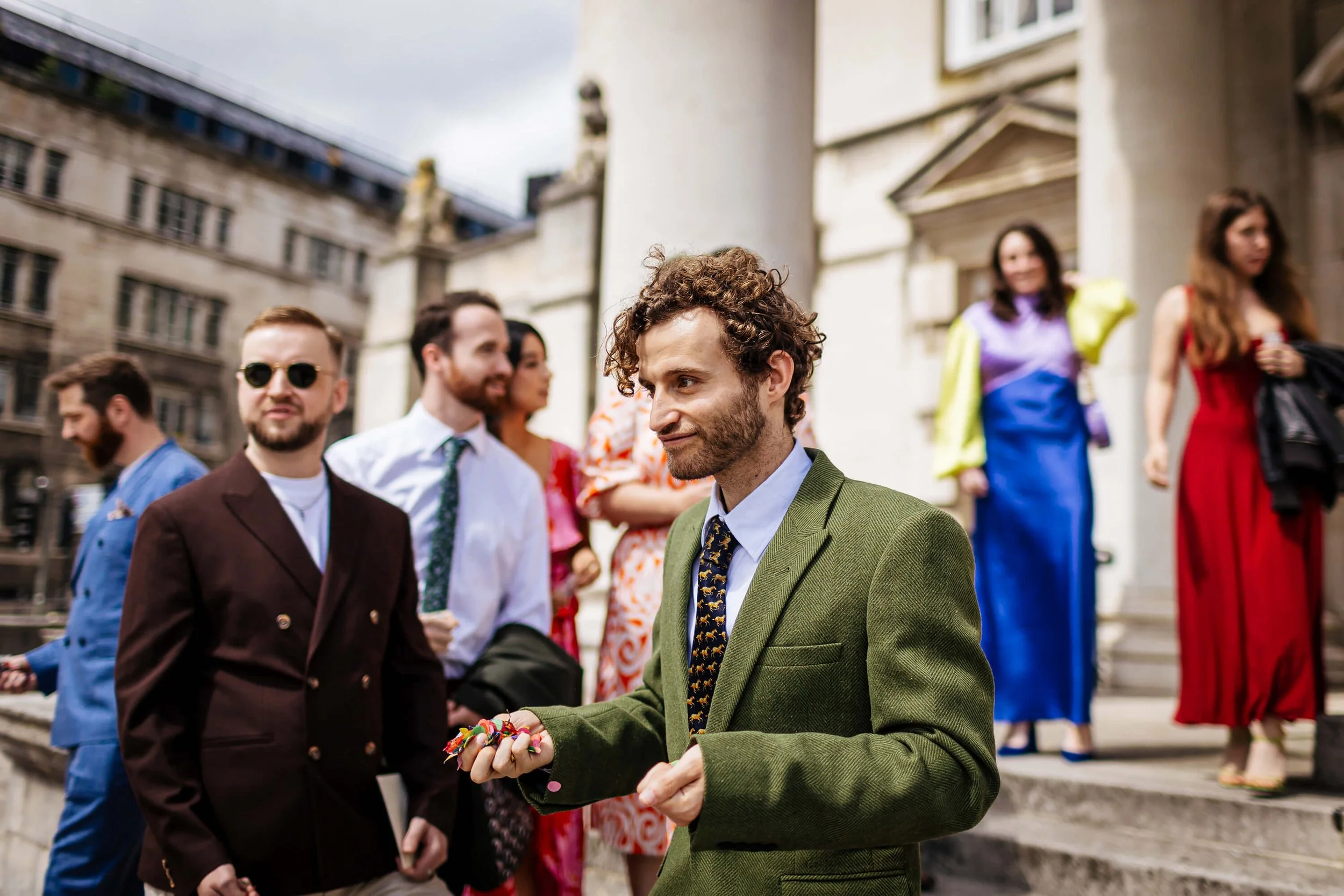Wedding guests holding confetti ready to throw it