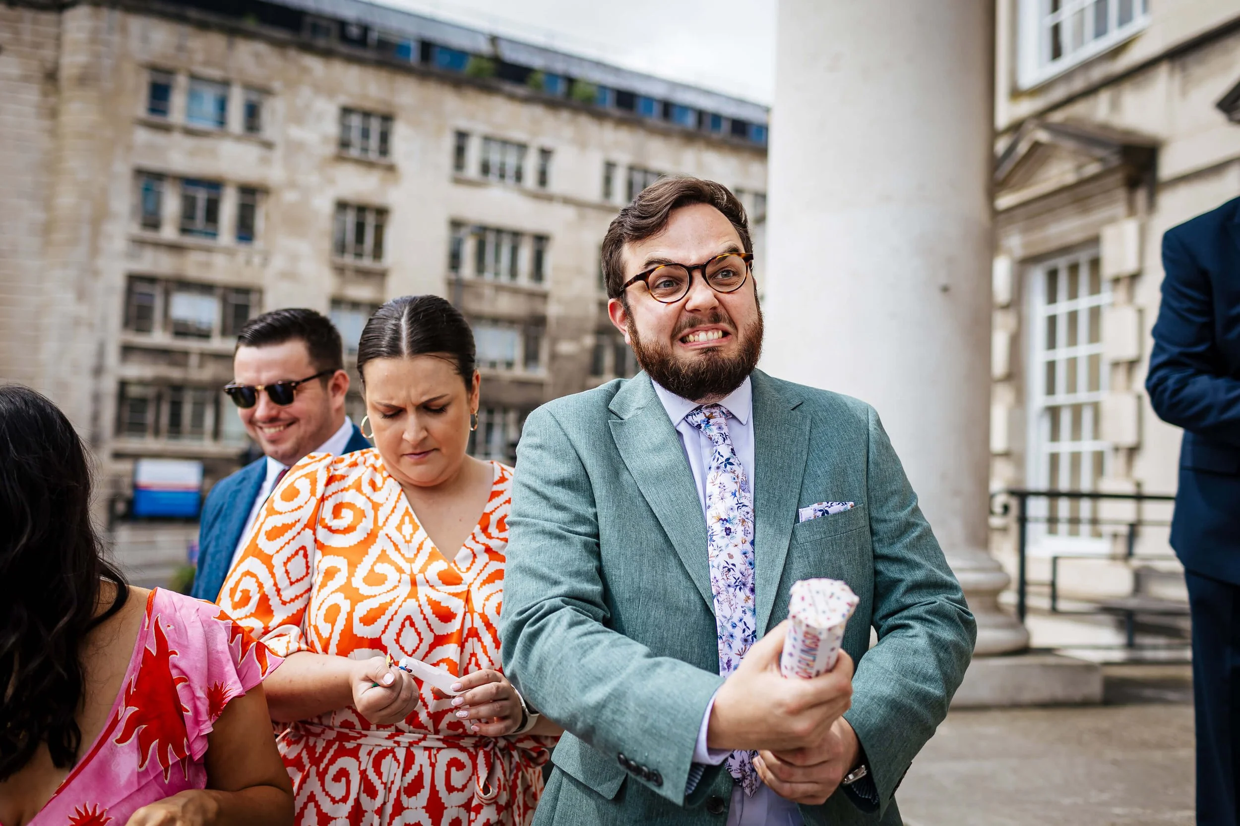 A wedding guest with a confetti cannon ready to fire