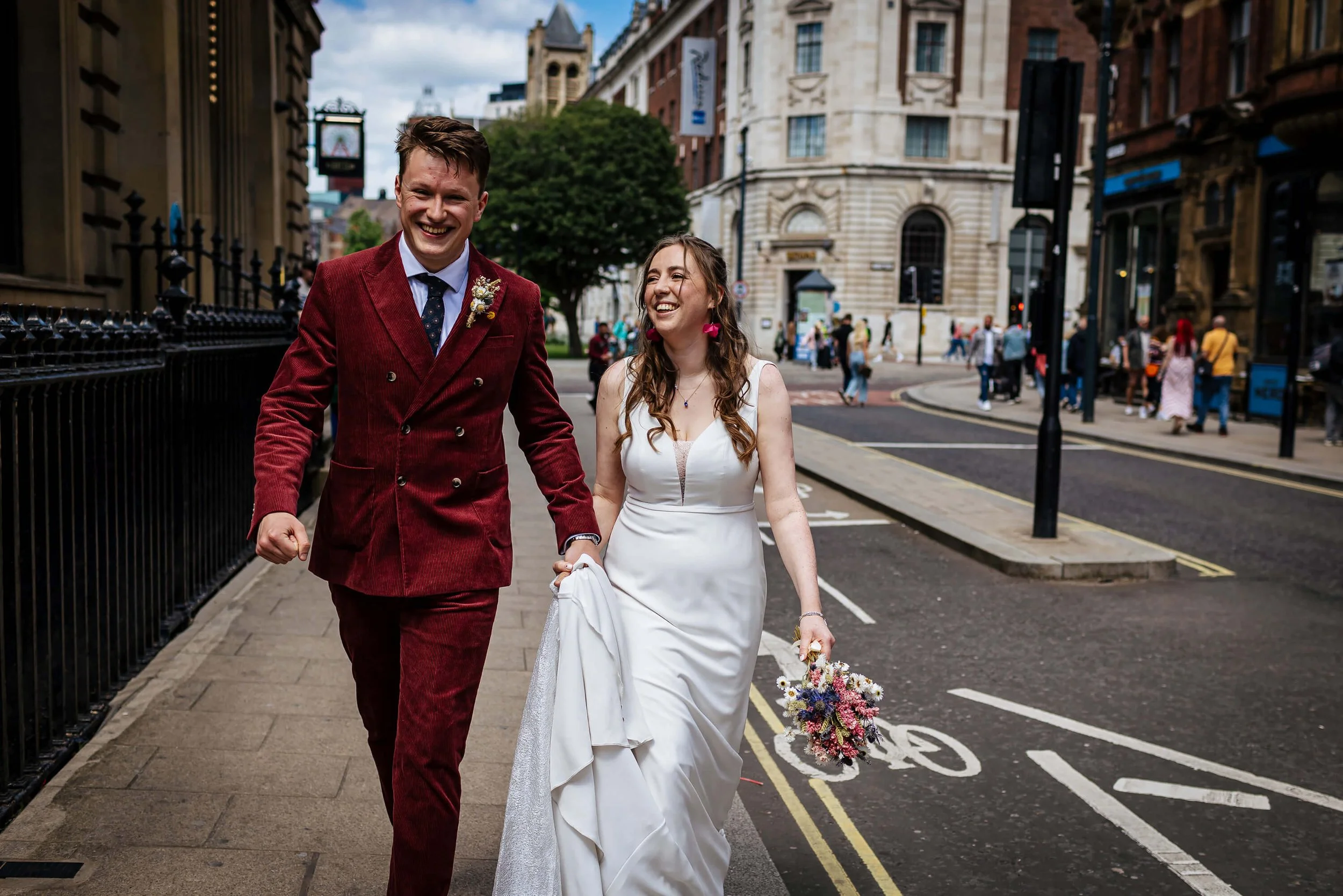 Bride and groom strolling through Leeds to their wedding reception