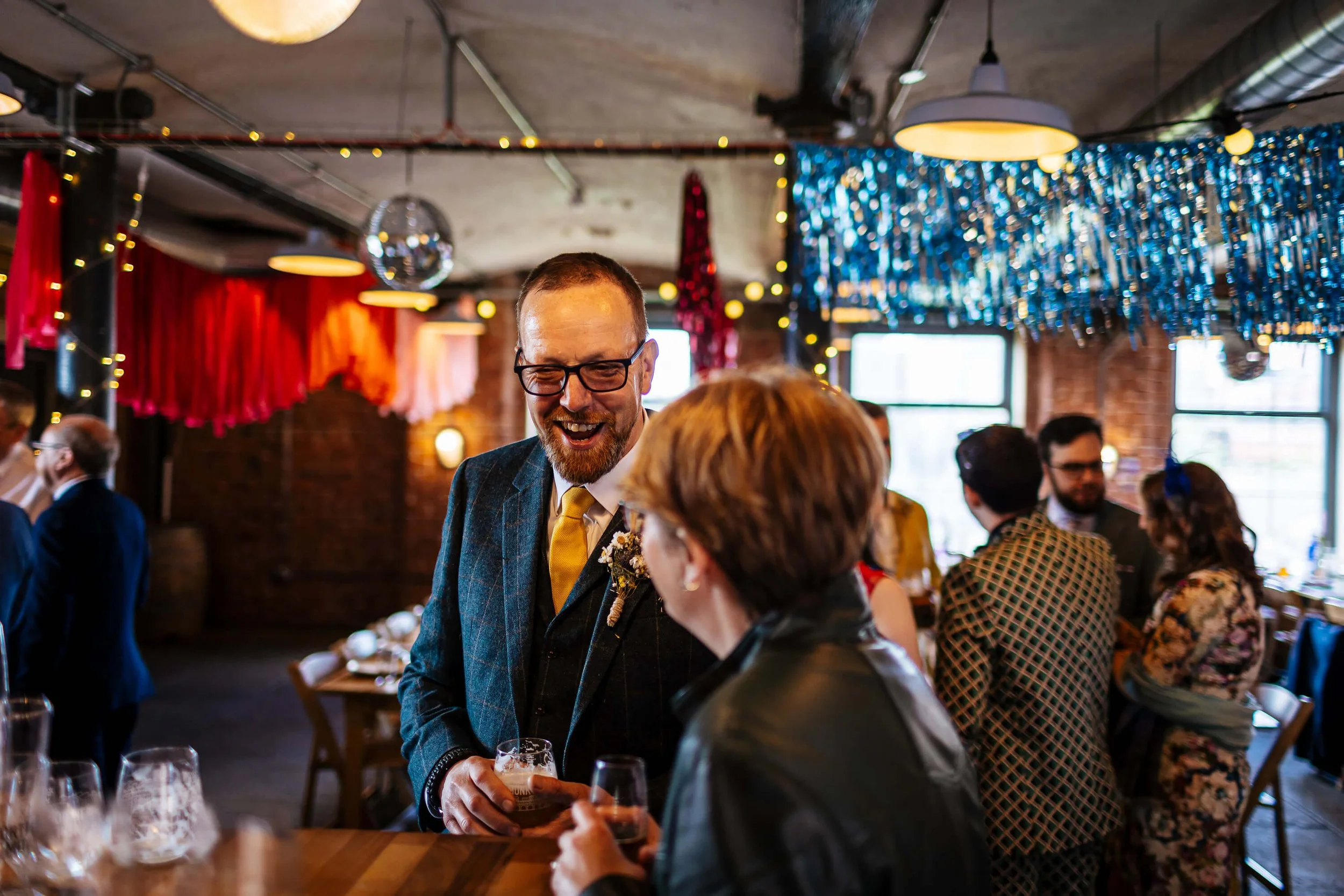 Wedding guests laughing at the reception