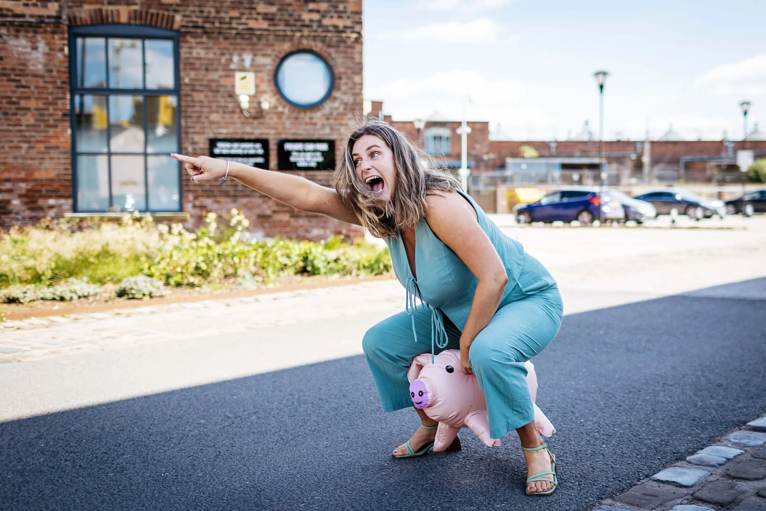 Wedding guest ringing the pig playfully