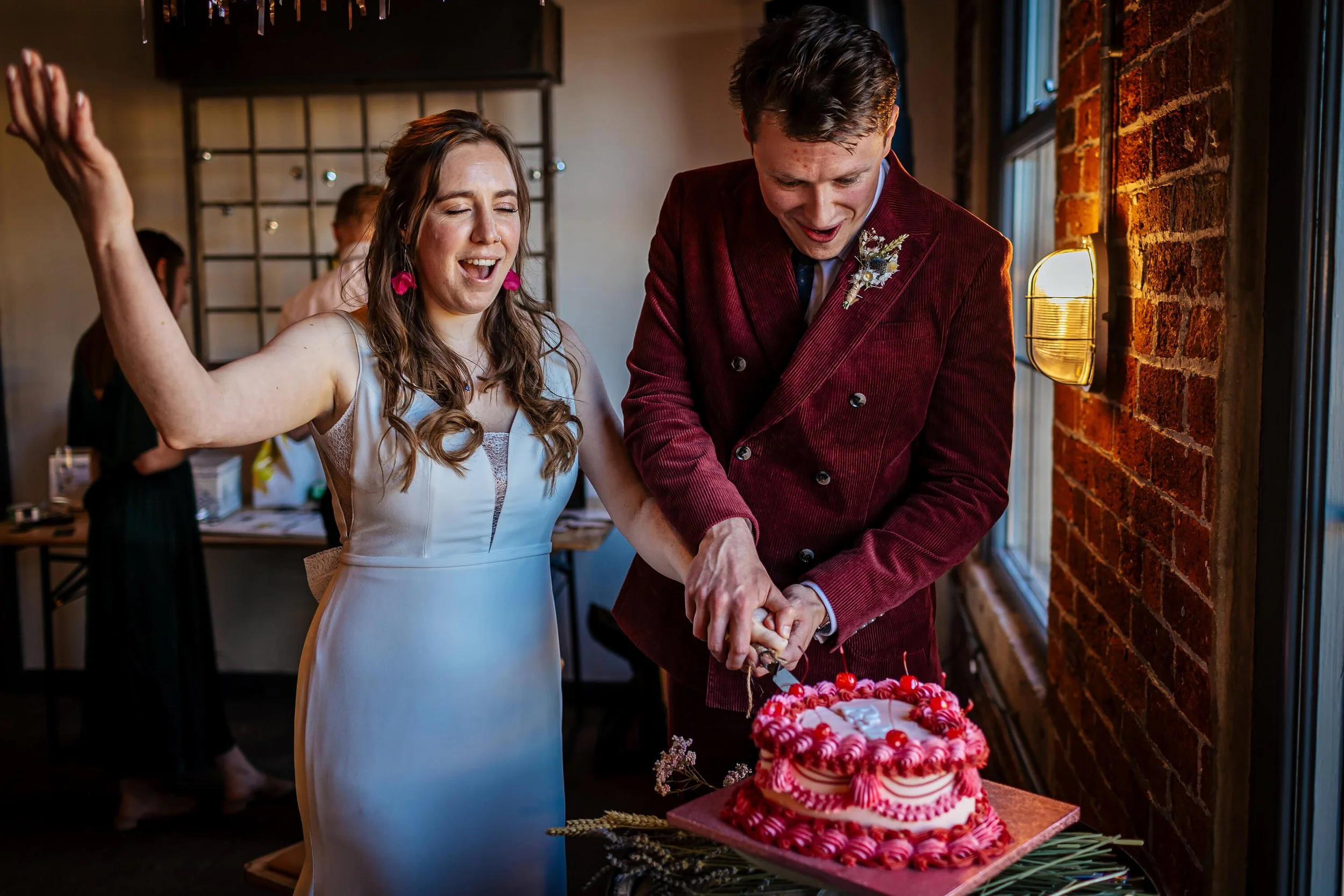 Bride and groom cut the cake at their wedding reception