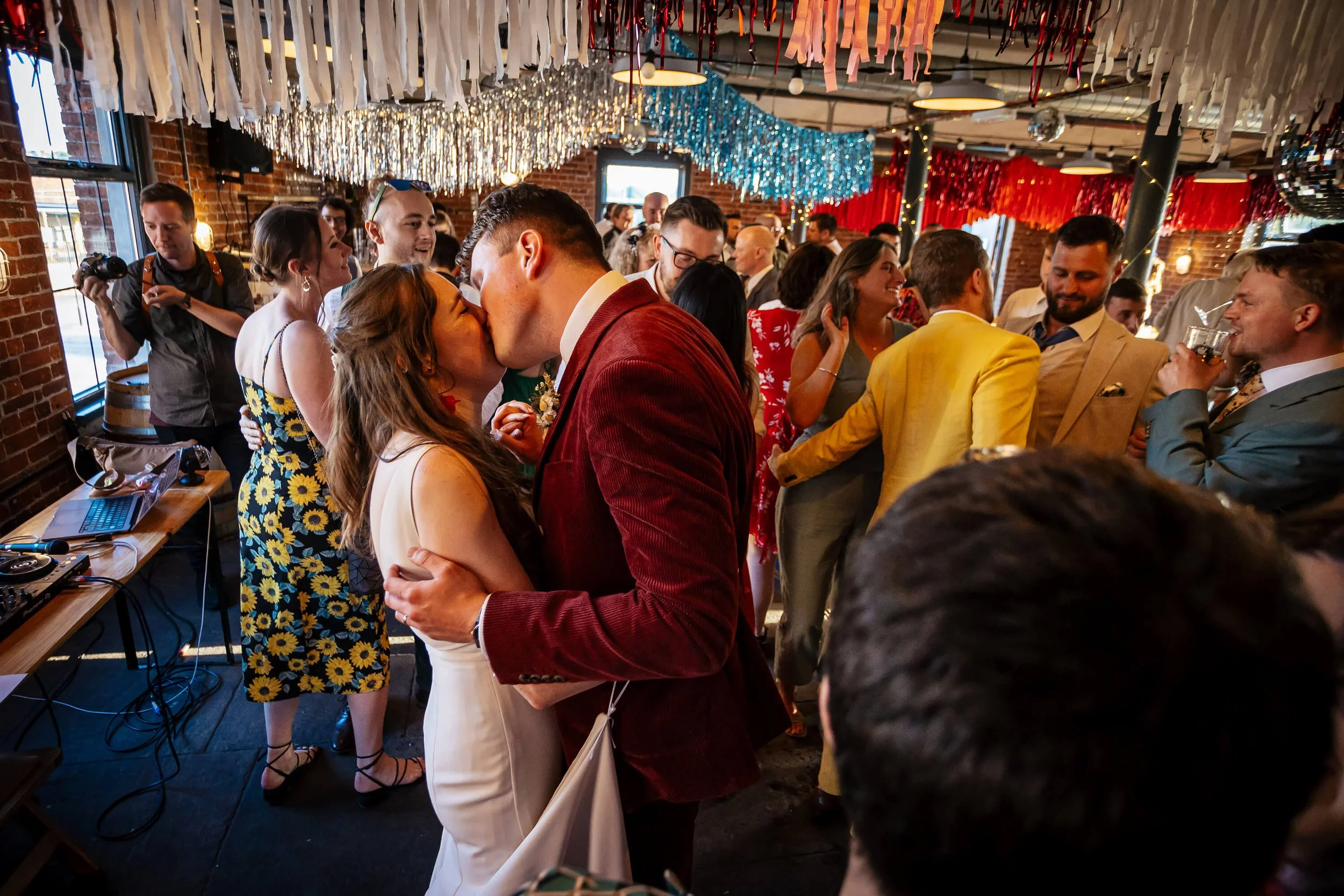 Bride and groom share a kiss on the dance floor in Leeds