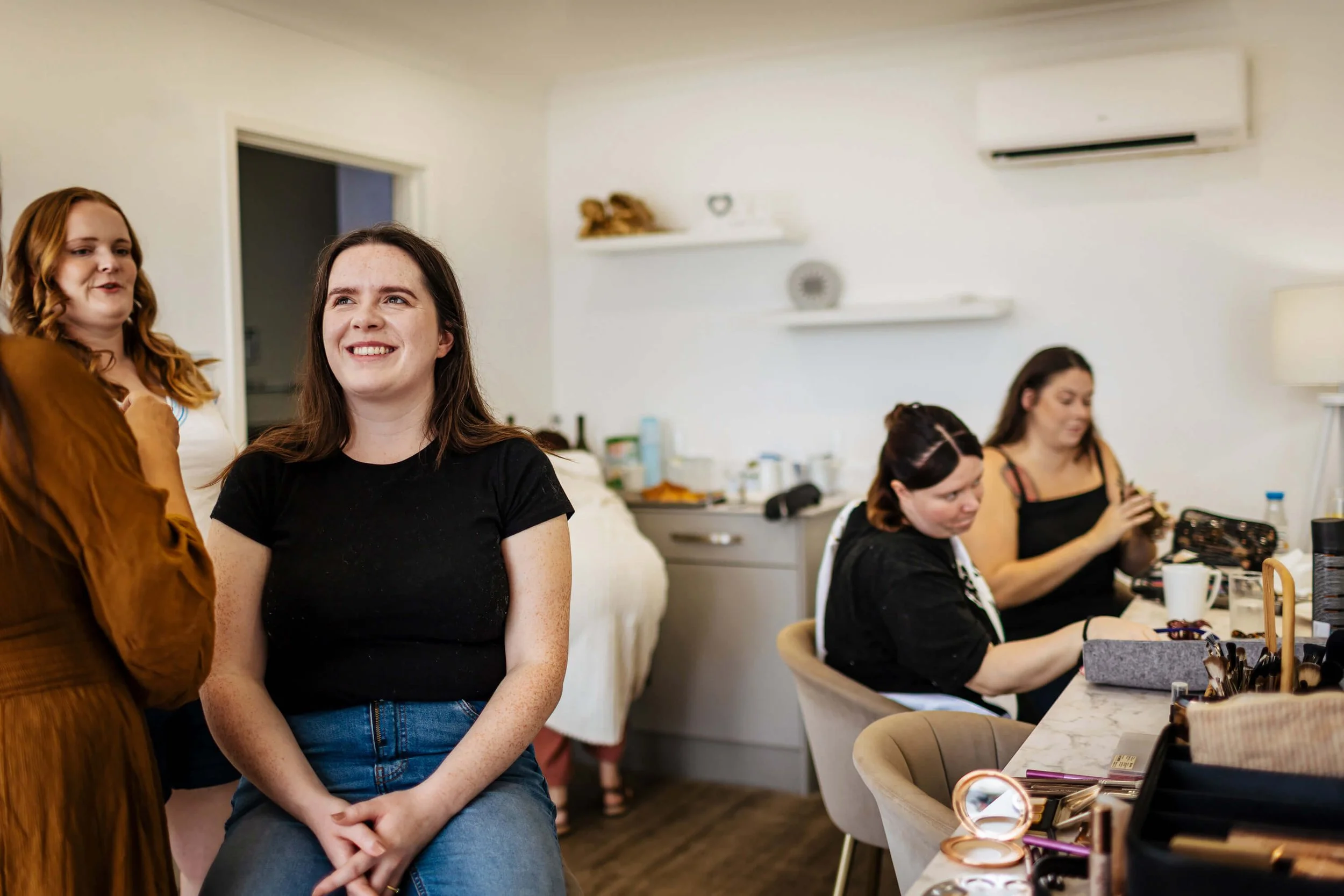 Bride getting ready on her wedding morning with the bridesmaids