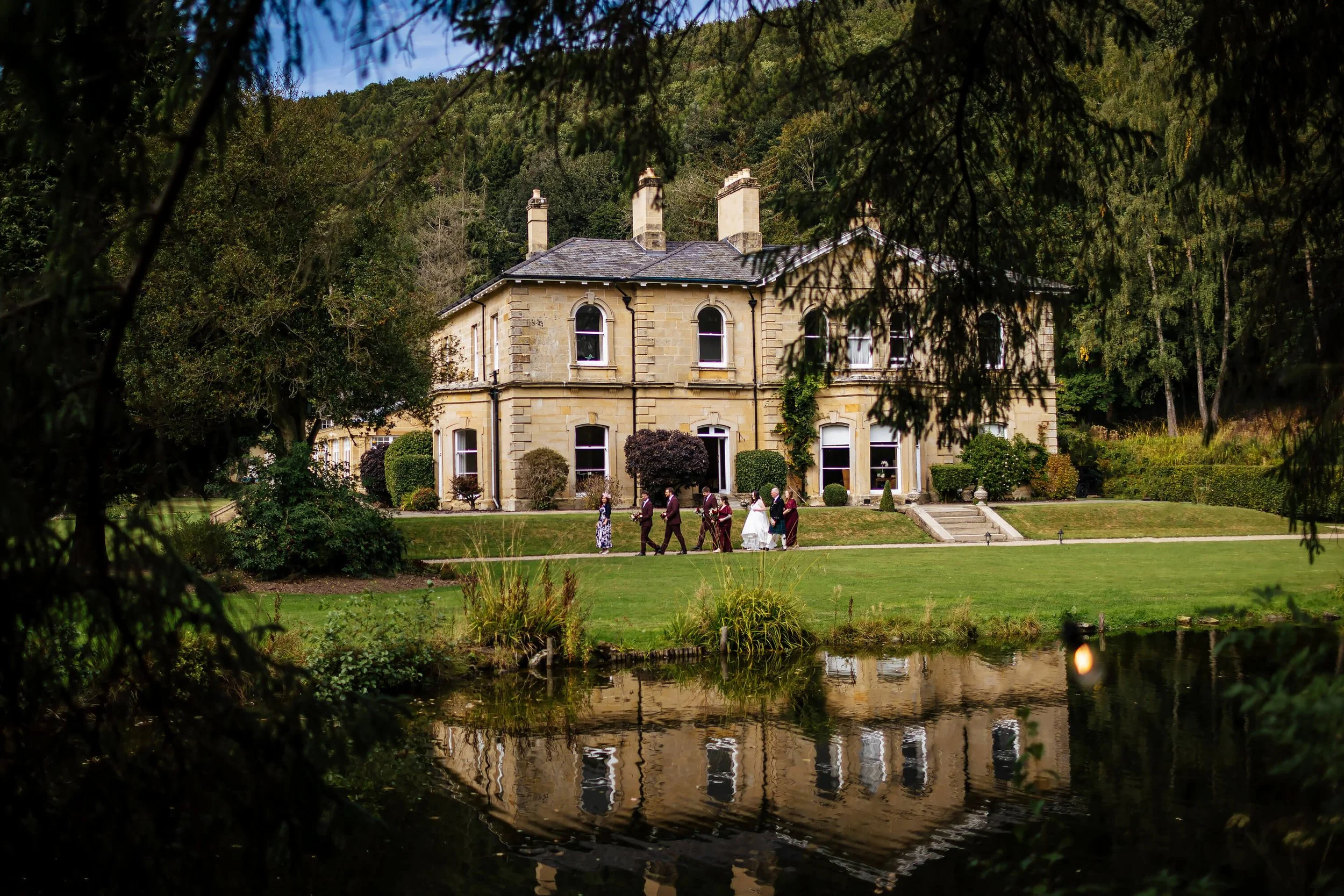 Bridal party walking towards the wedding ceremony at Hackness Grange