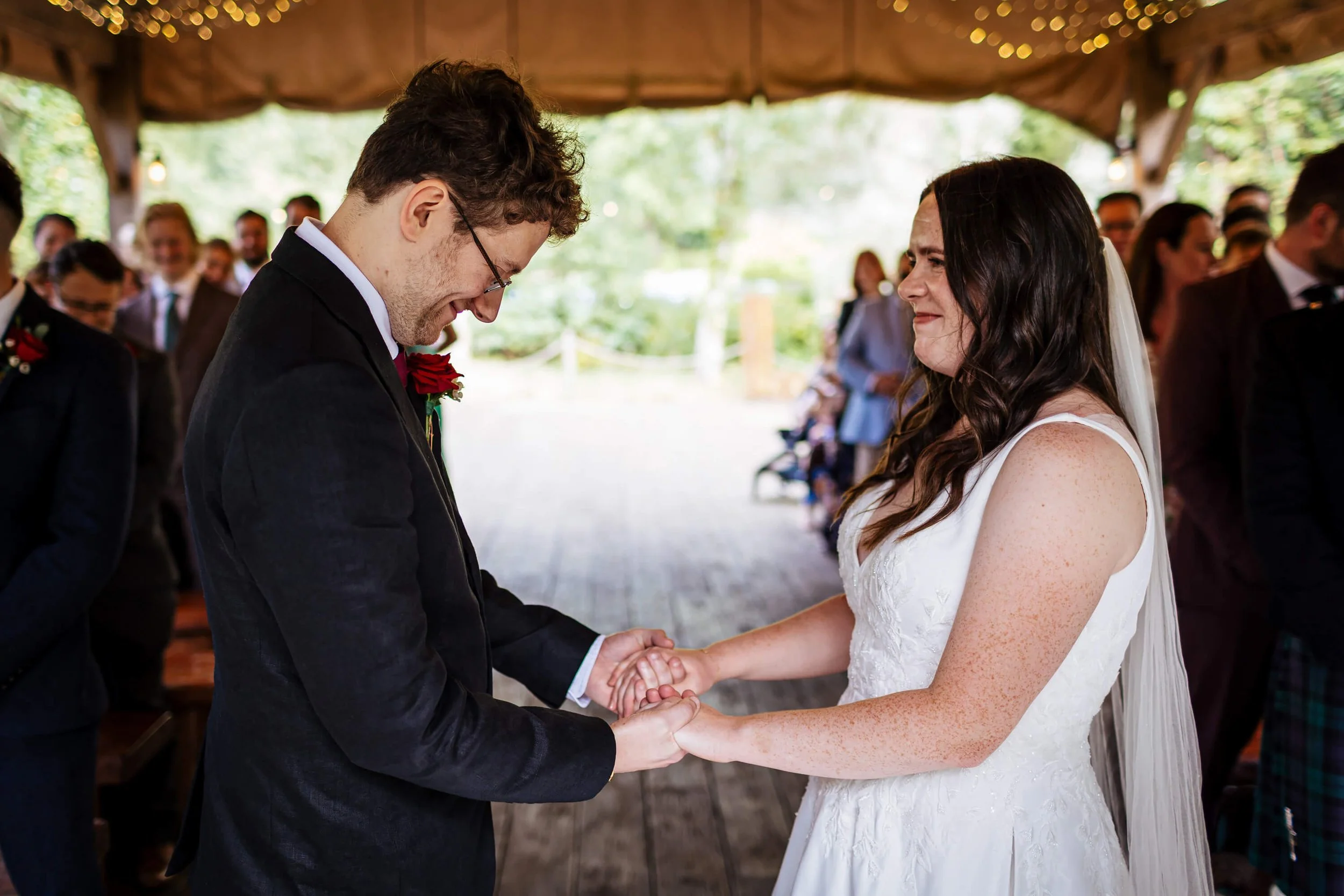 Bride and groom hold hands at their wedding in Yorkshire