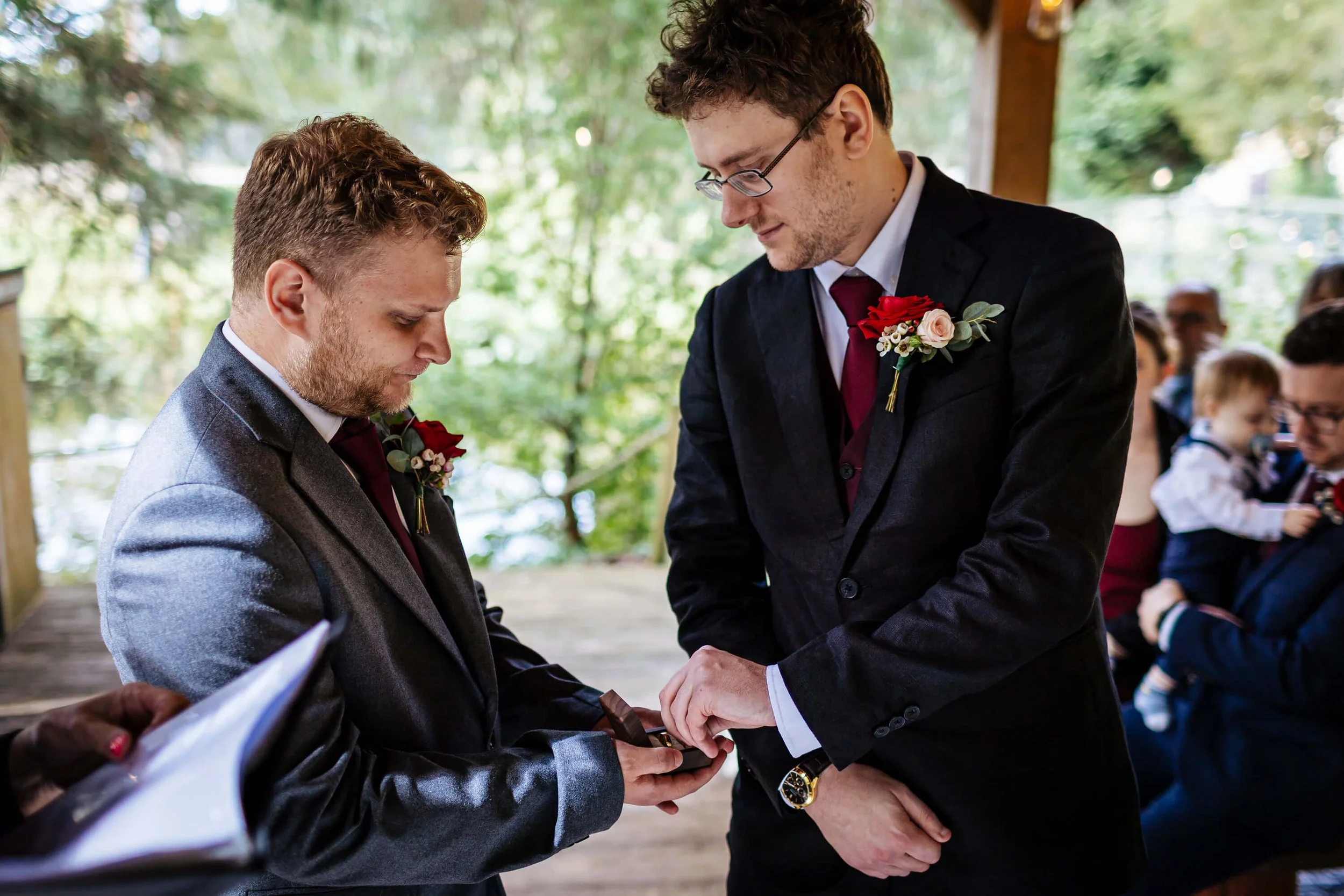 The best man present the wedding during to the groom during the ceremony