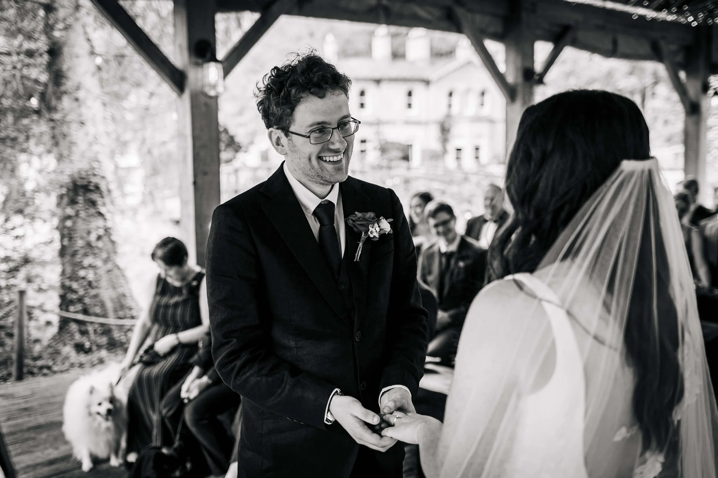 Groom putting the ring on his bride's finger at a wedding