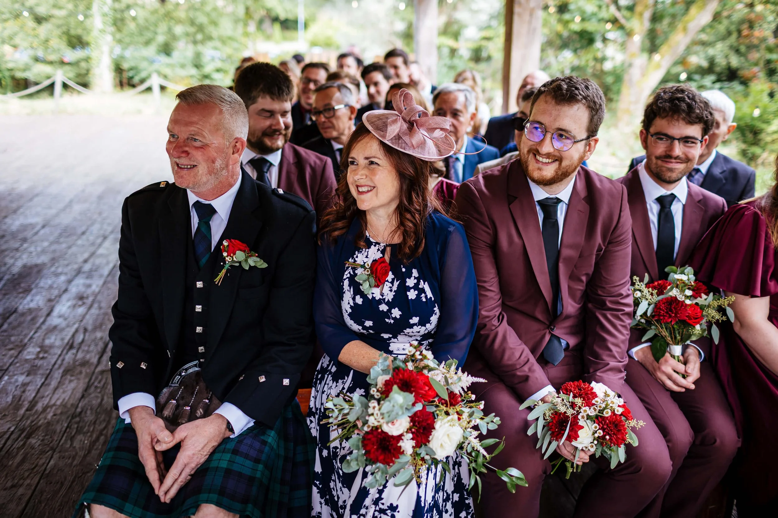 Wedding guests smiling and laughing during the ceremony