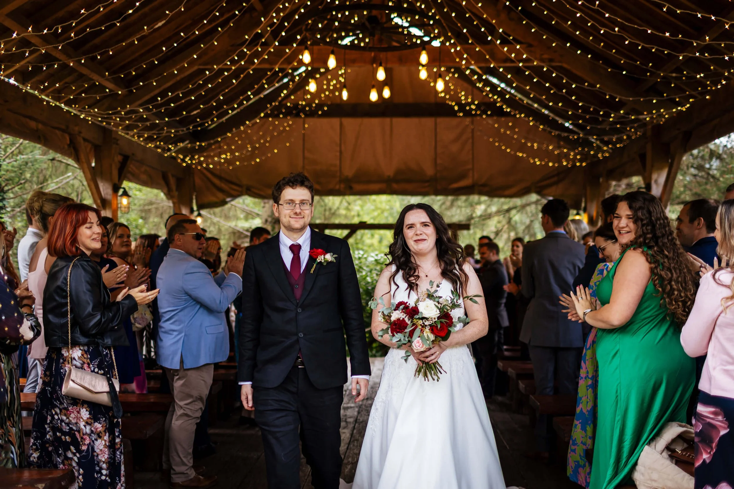 Walking down the aisle from the ceremony as man and wife