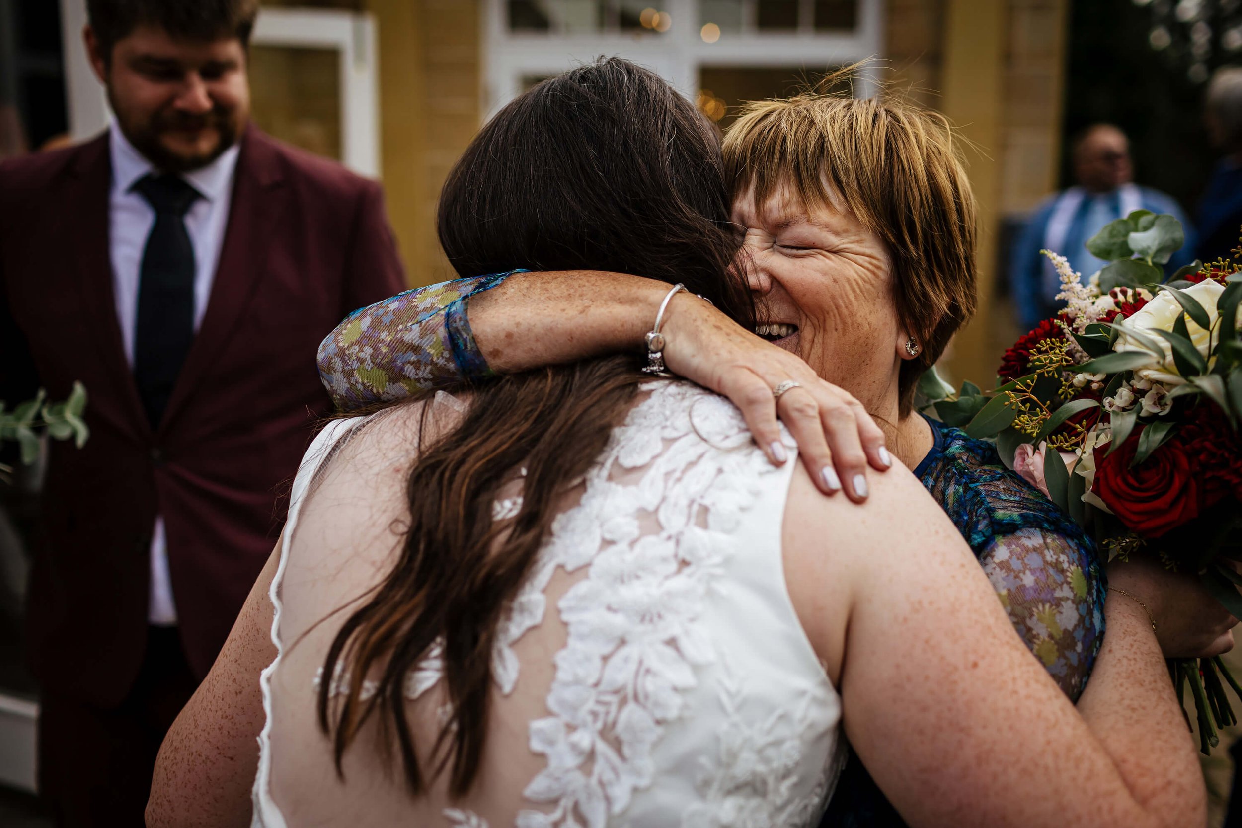 Wedding guest and bride hugging after the ceremony